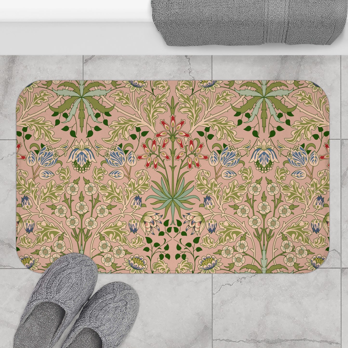 A rectangular microfibre bath mat with a floral pattern inspired by William Morris, in colours pink, green, and white.