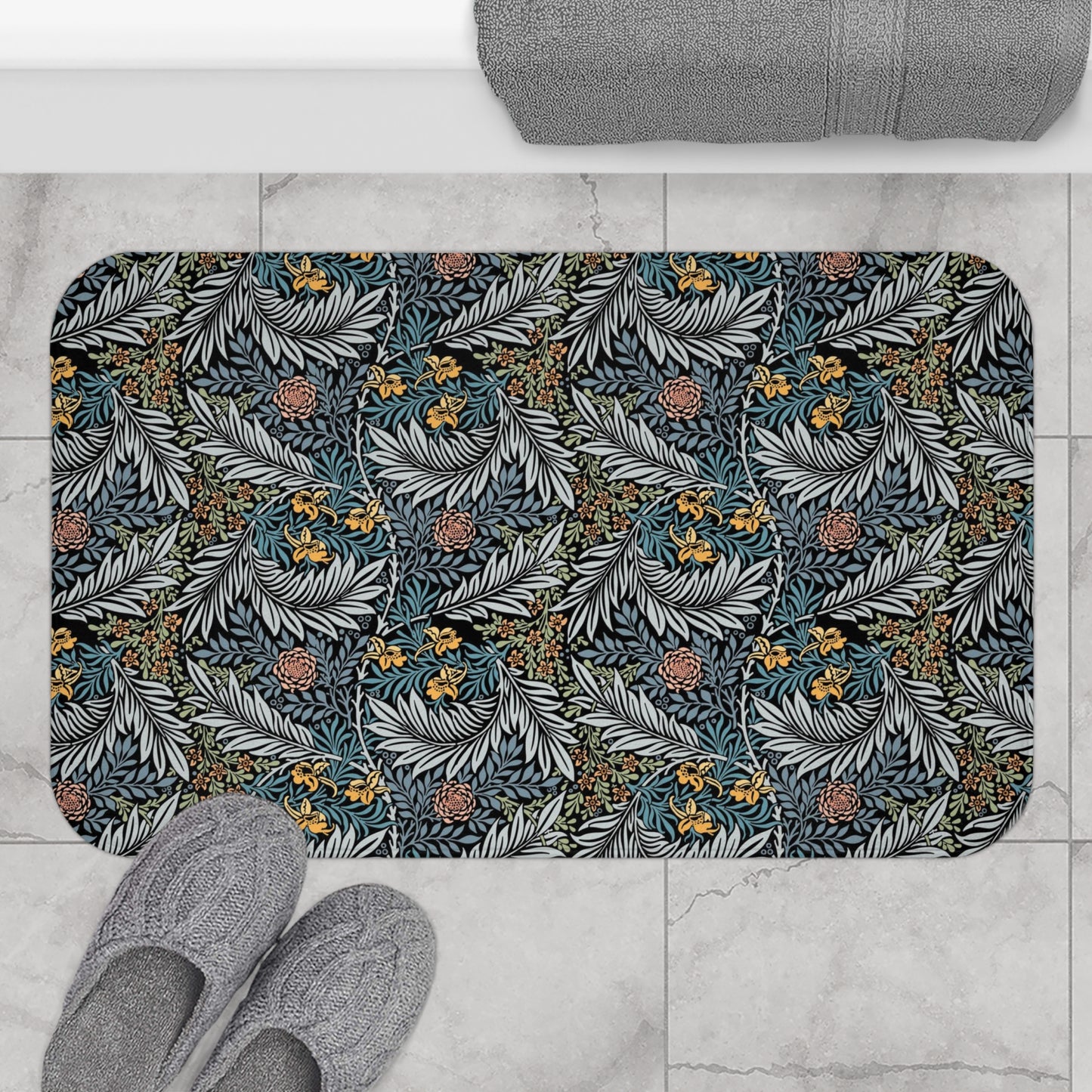 A rectangular microfibre bath mat with a blue background featuring an elegant floral pattern inspired by William Morris' work.