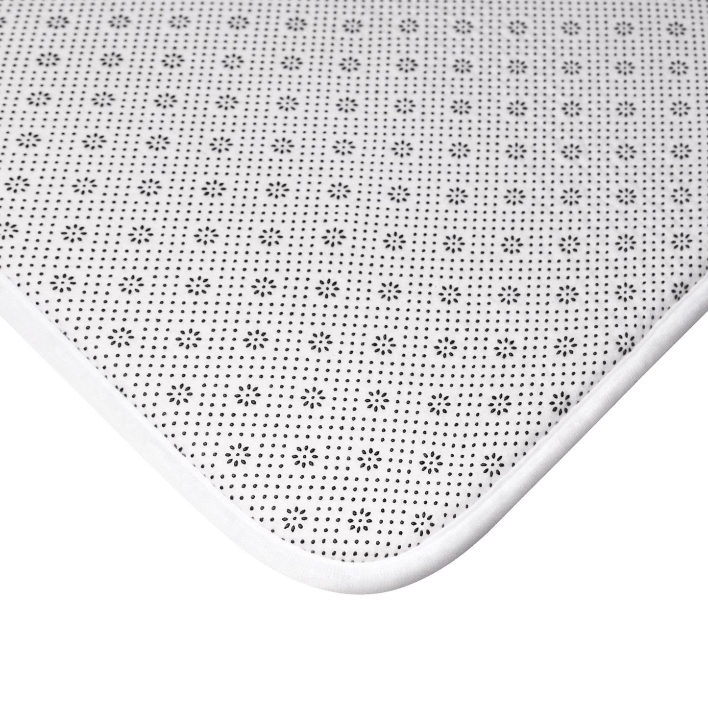 Rectangular microfibre bath mat with a pink flower and seaweed pattern inspired by William Morris.