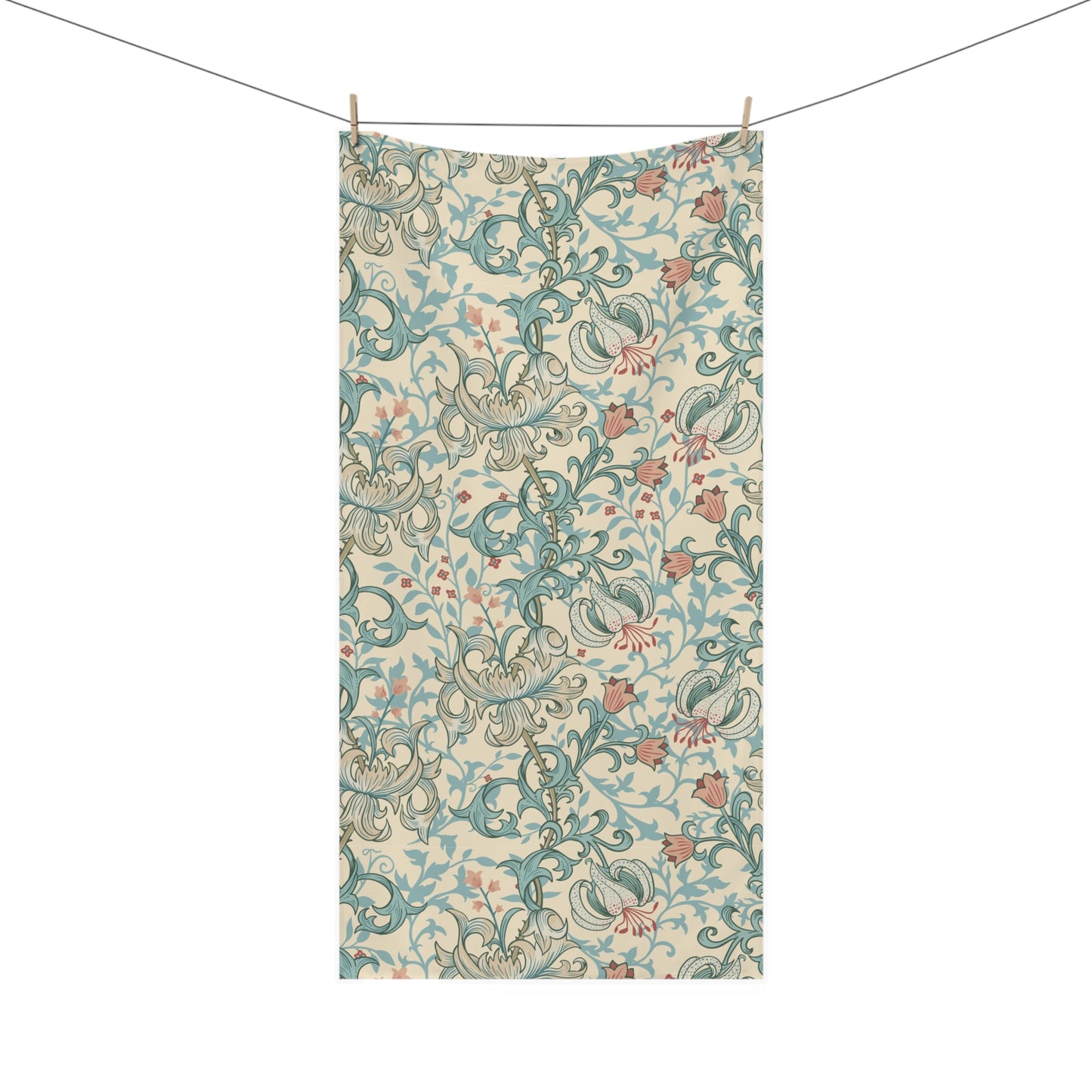 A rectangular fabric towel or scarf with an intricate floral and scroll pattern in teal, dusty pink, and olive green on a cream background, hanging from a clothesline with two wooden clips against a solid white background.