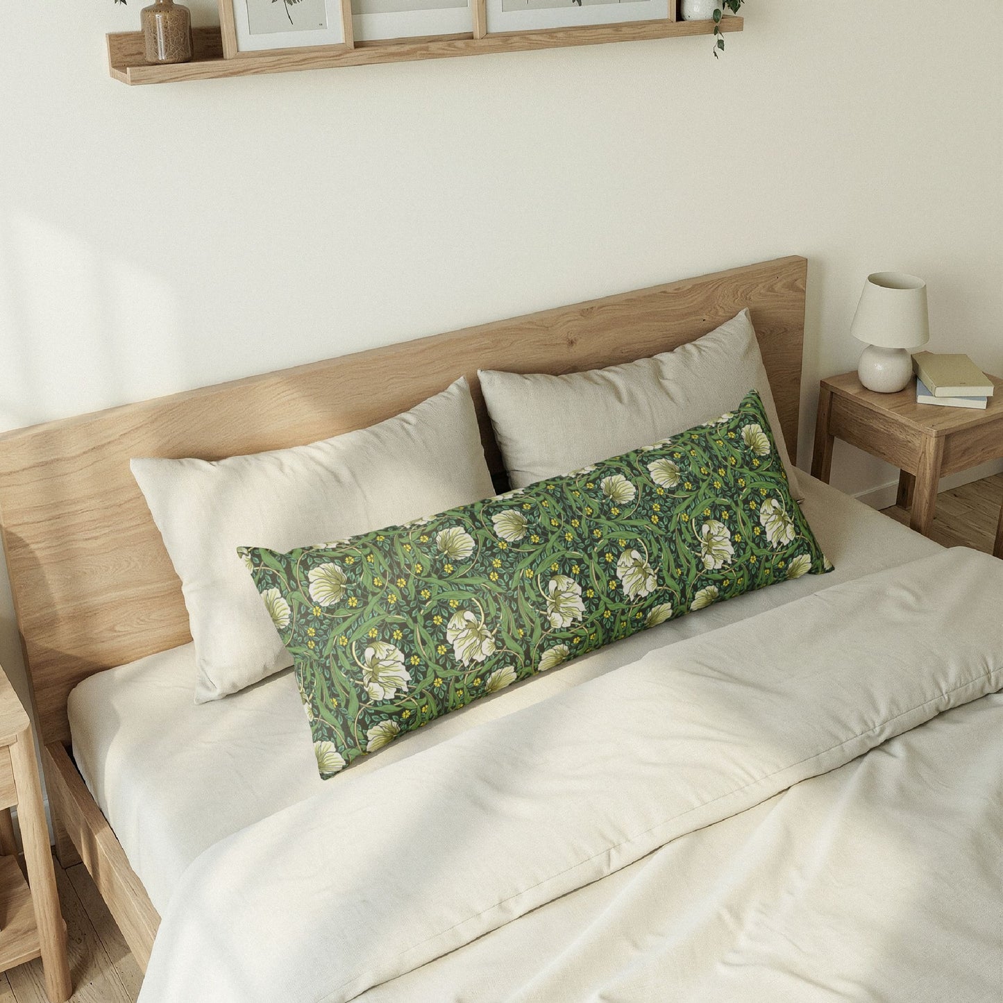 Bedroom with a wooden bed frame, white bedding, and a decorative green pillow.