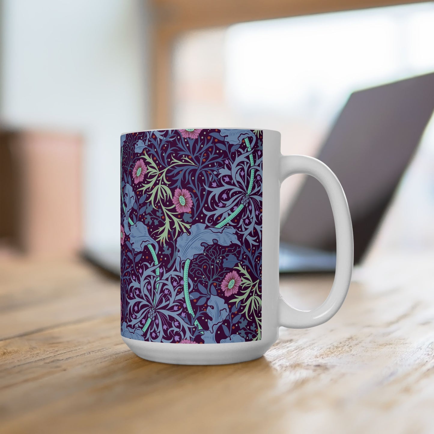 A white ceramic mug with a pink floral seaweed pattern inspired by William Morris.