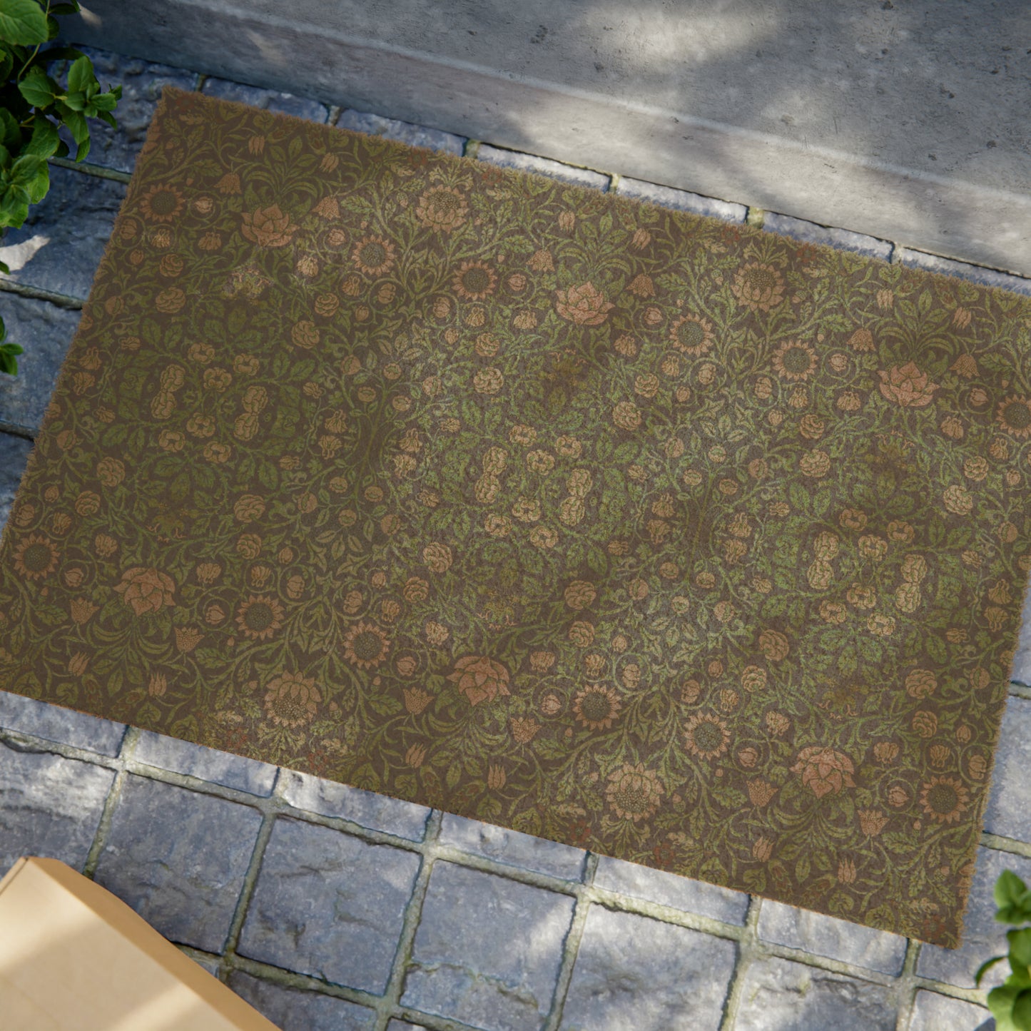 A rectangular green coconut coir doormat with an intricate geometric floral William Morris & Co pattern and a black vinyl backing, designed for outdoor use.