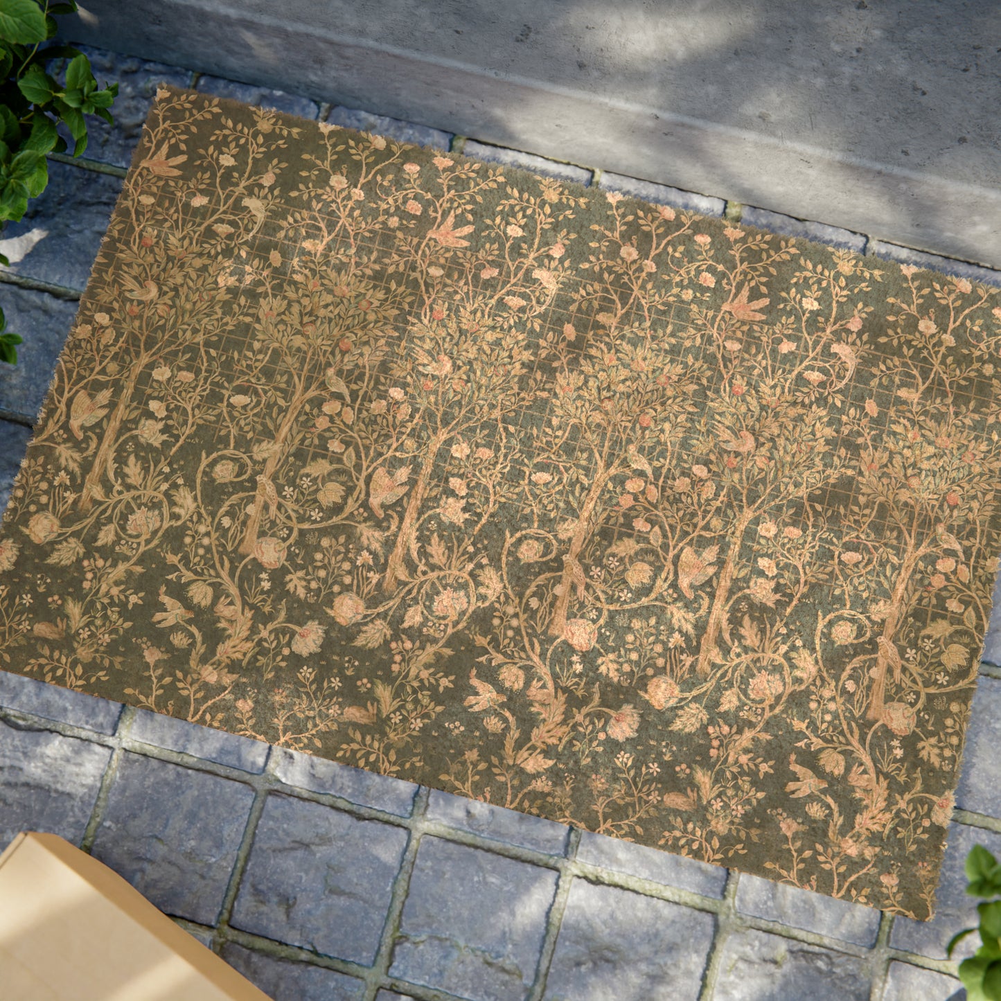 Rectangular coconut coir doormat with an intricate William Morris & Co floral pattern in a teal colour, featuring a black vinyl backing.