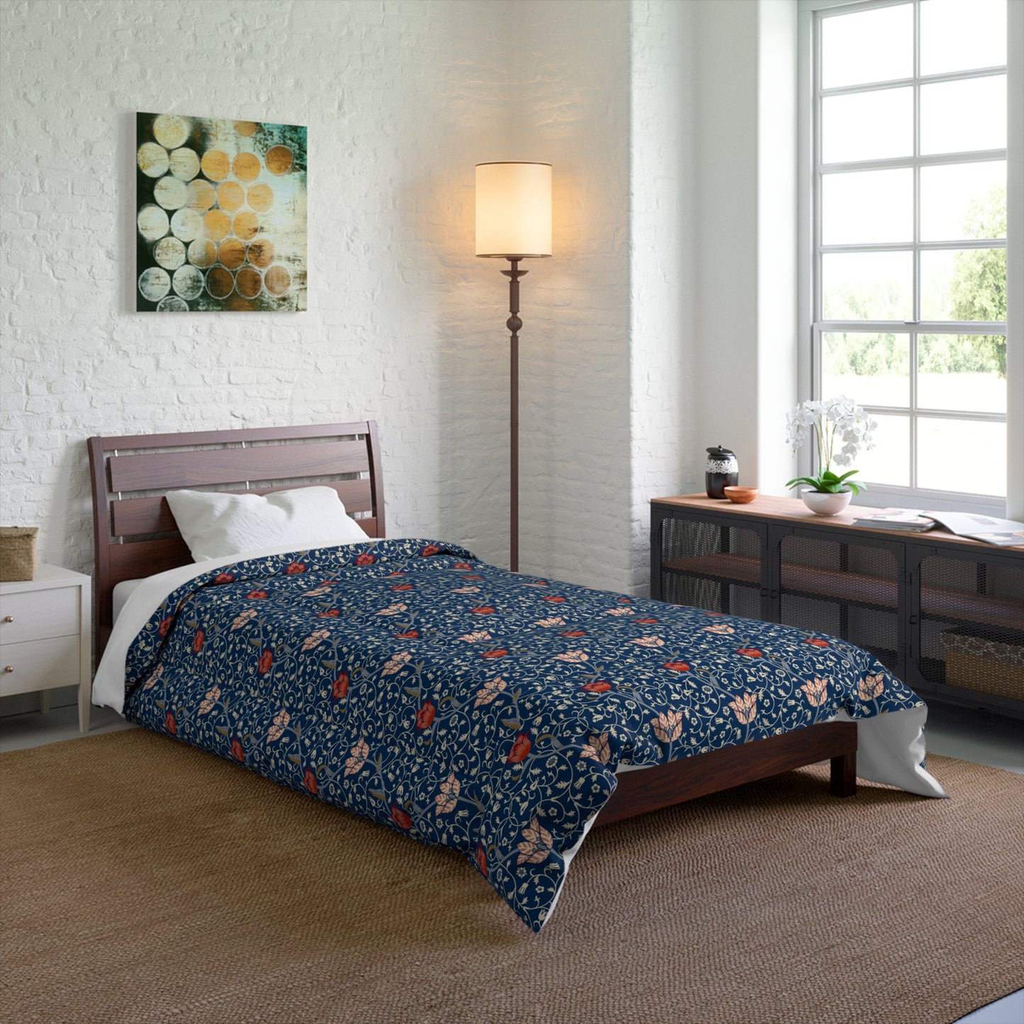 A square-shaped comforter with a blue background featuring a repeating William Morris & Co pattern of red and white apple designs and a plush batting layer visible on one side.
