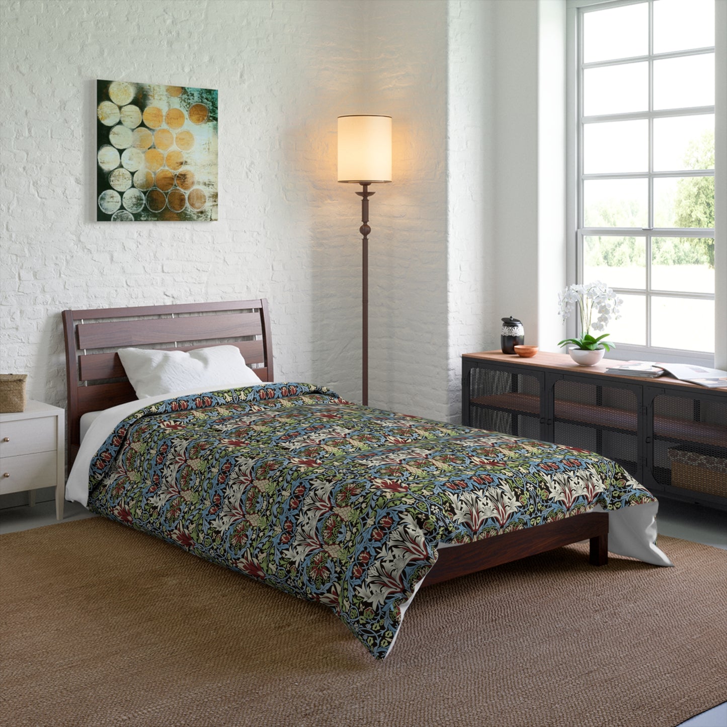 Bedroom with floral comforter on bed, lamp, and artwork on wall from William Morris