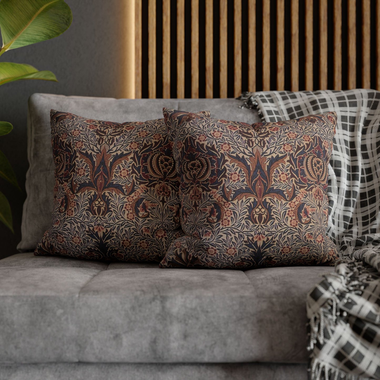 Patterned pillows on a gray sofa with a wooden headboard in the background