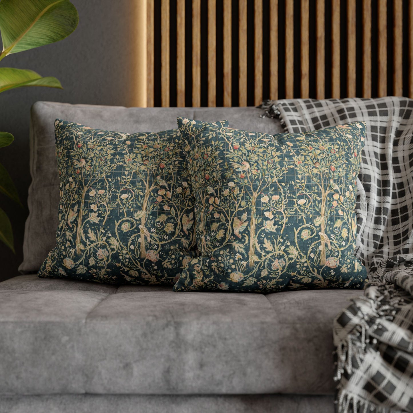 Decorative pillows on a gray sofa with a wooden panel background