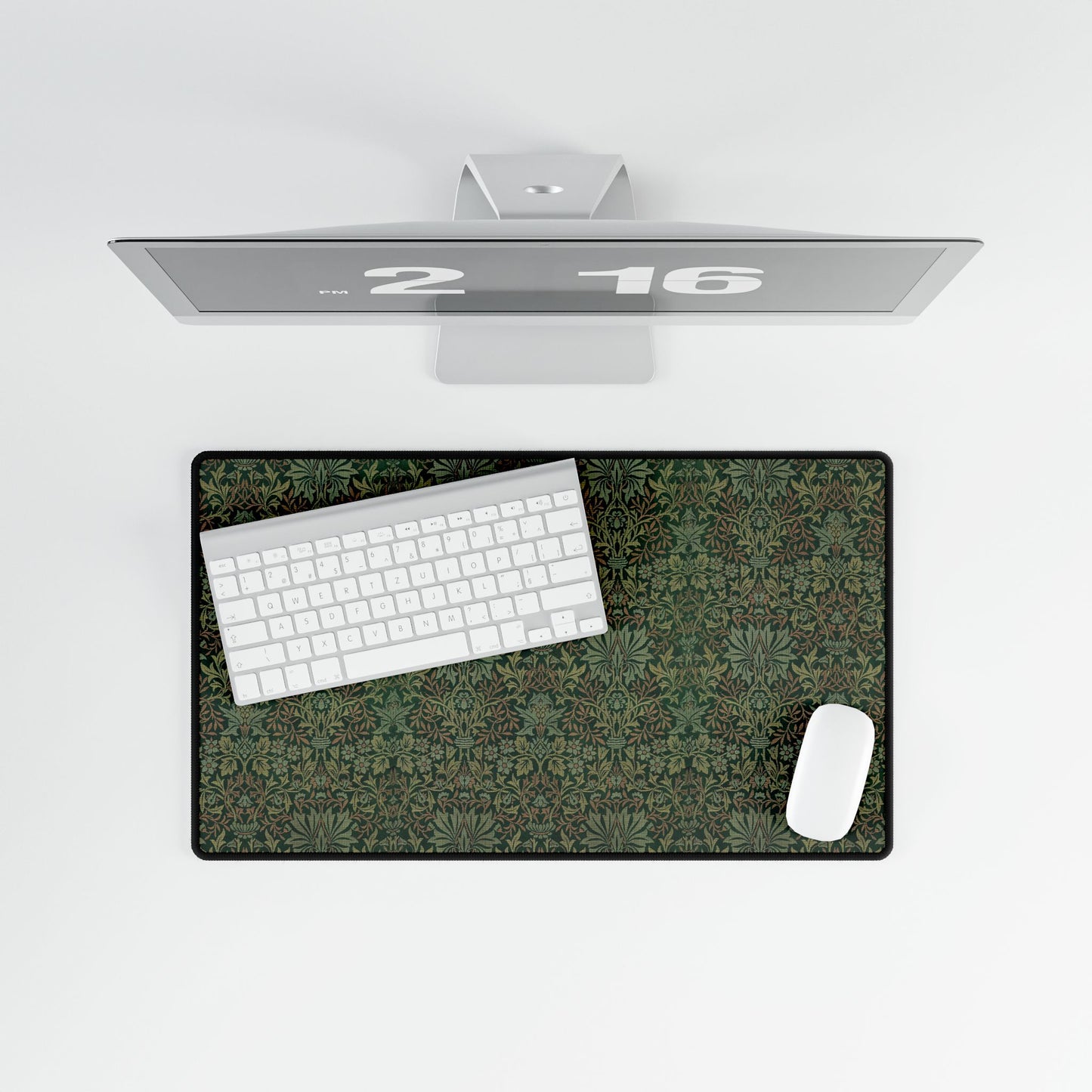 A rectangular desk mat with a floral garden pattern, placed under a desk with a keyboard and mouse on top.