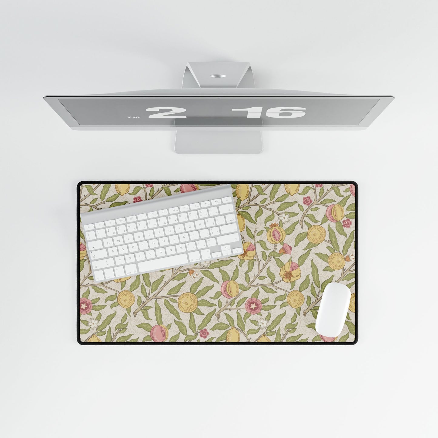 Floral patterned desk mat with a computer setup on a white background