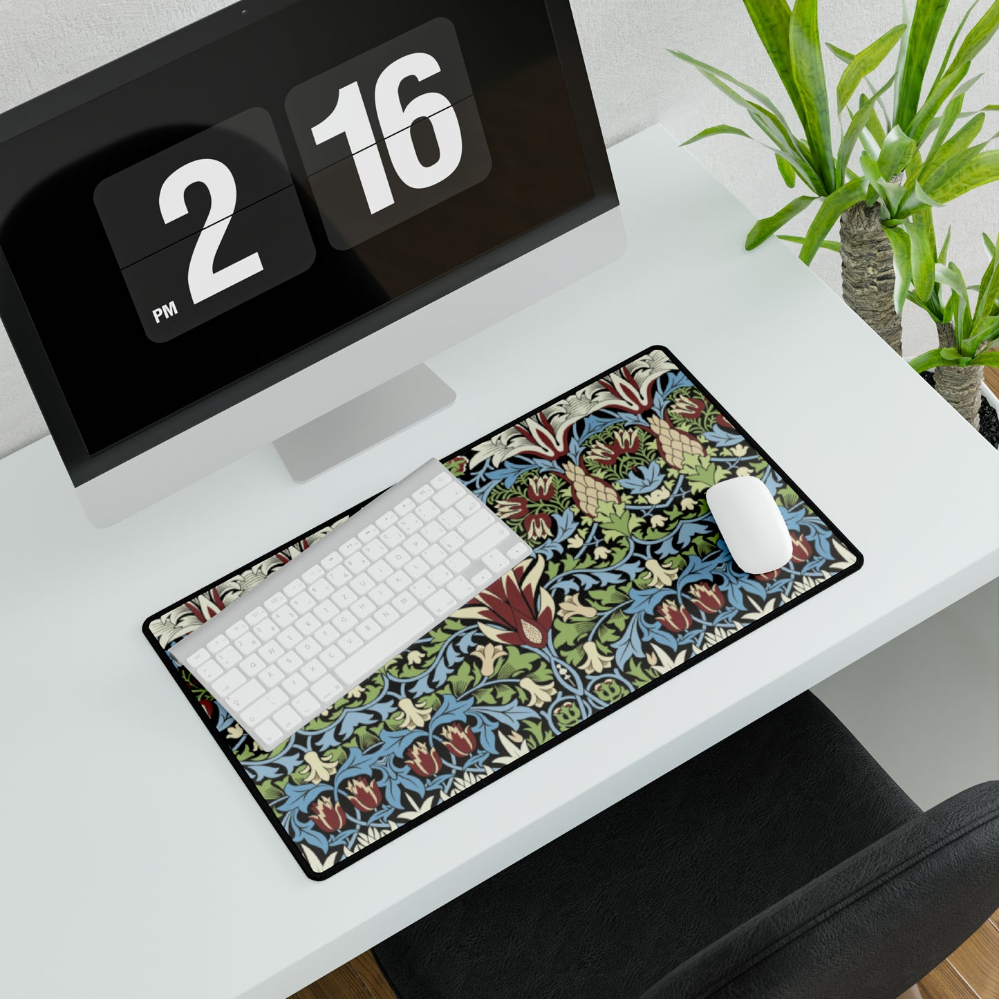 A large, decorative desk mat with a floral and geometric William Morris & Co pattern, displayed on a desk with a keyboard and mouse.