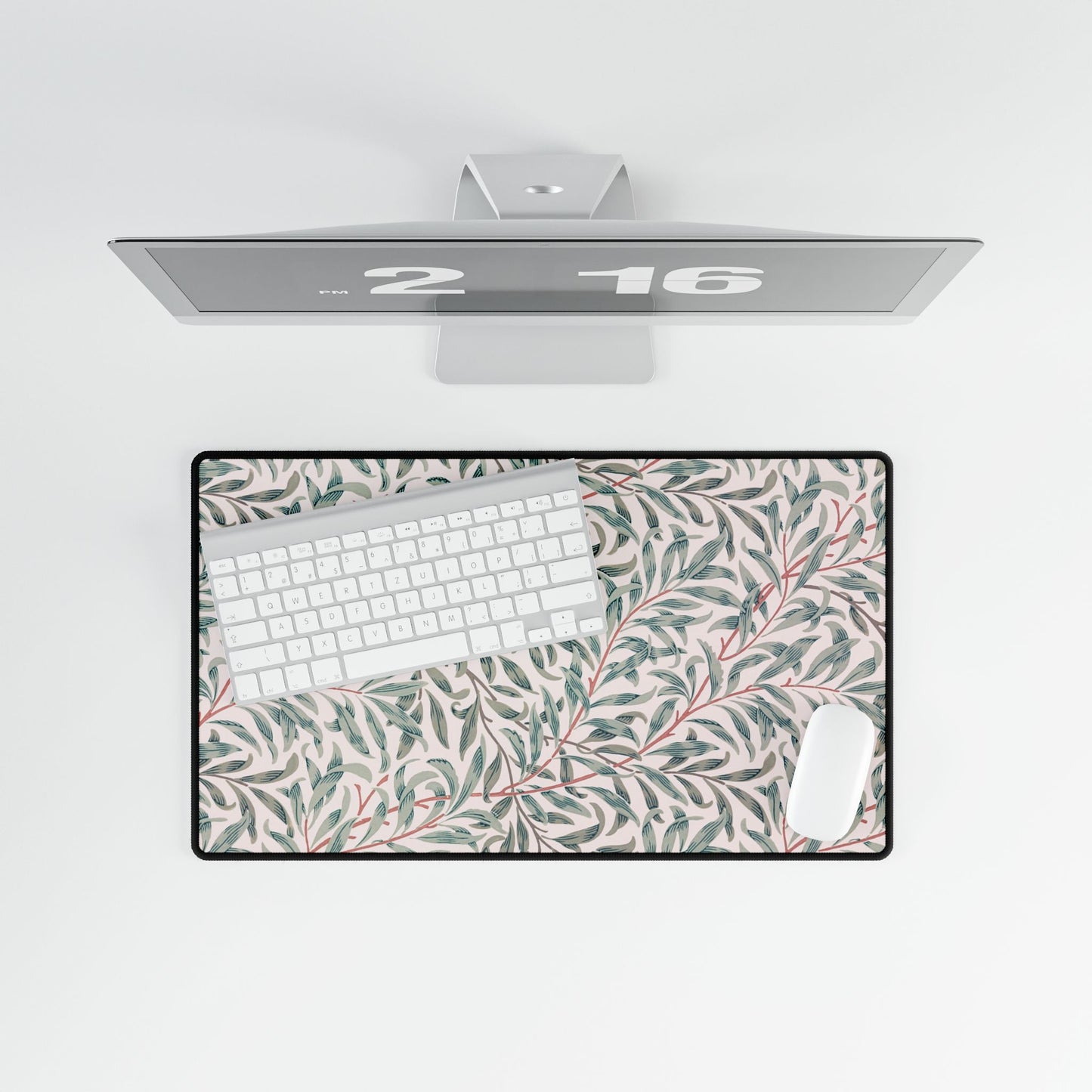Floral desk mat with a computer setup on a white background