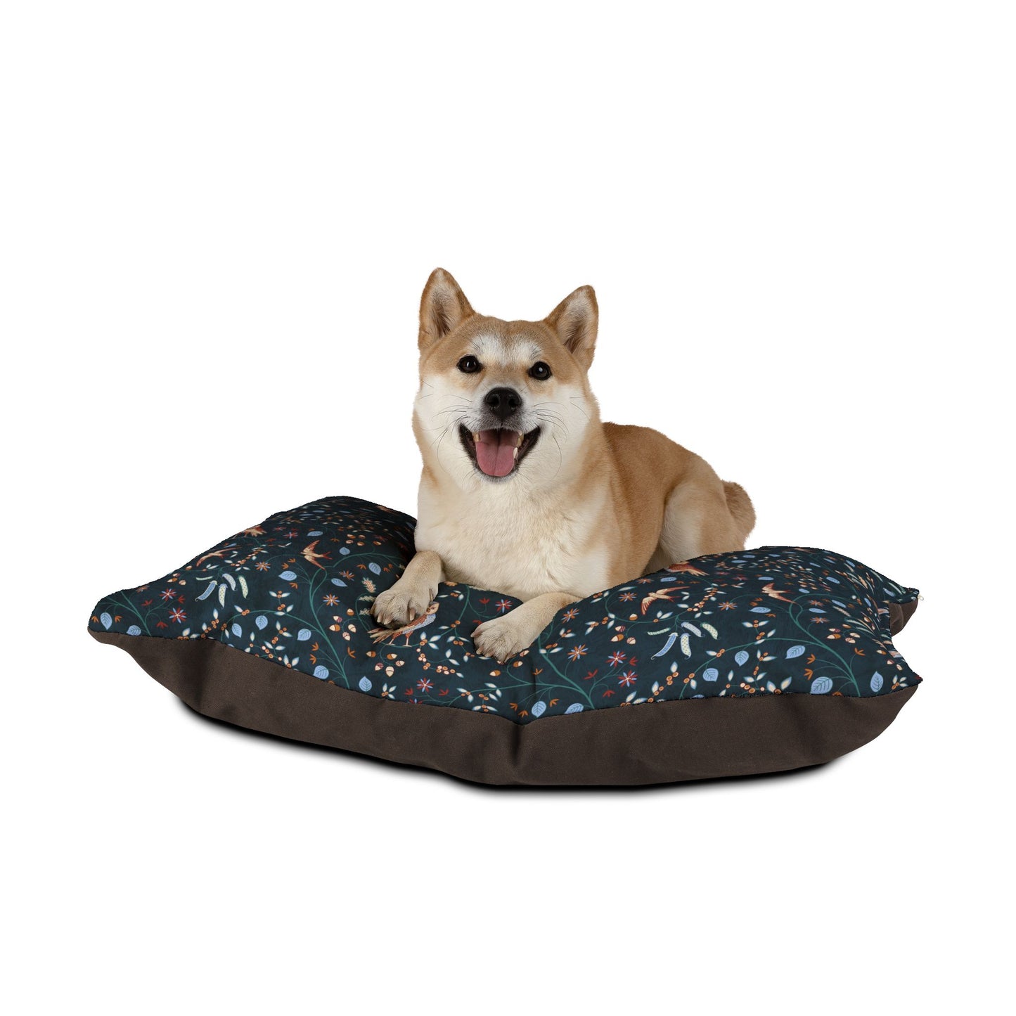 Dog sitting on a floral-patterned dog bed with a white background