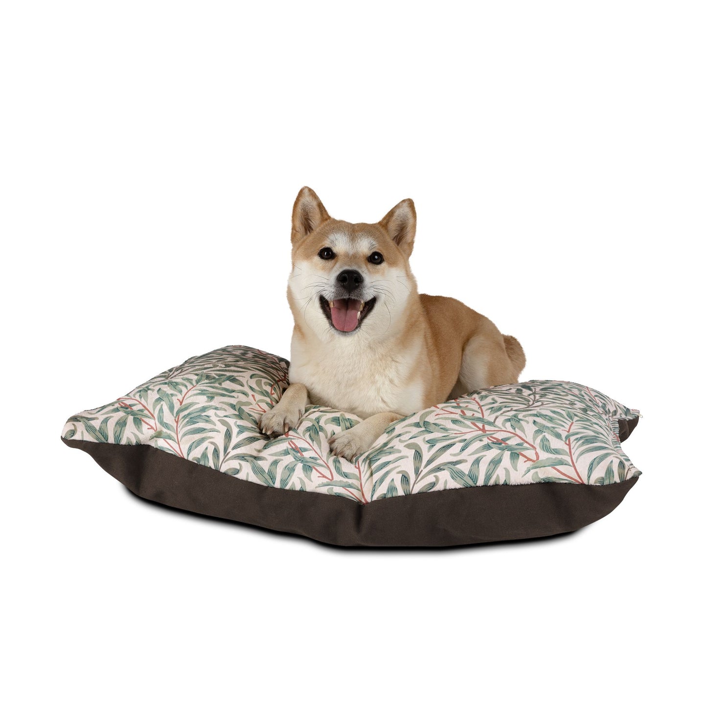 Dog sitting on a colorful geometric-patterned pet bed with a white background