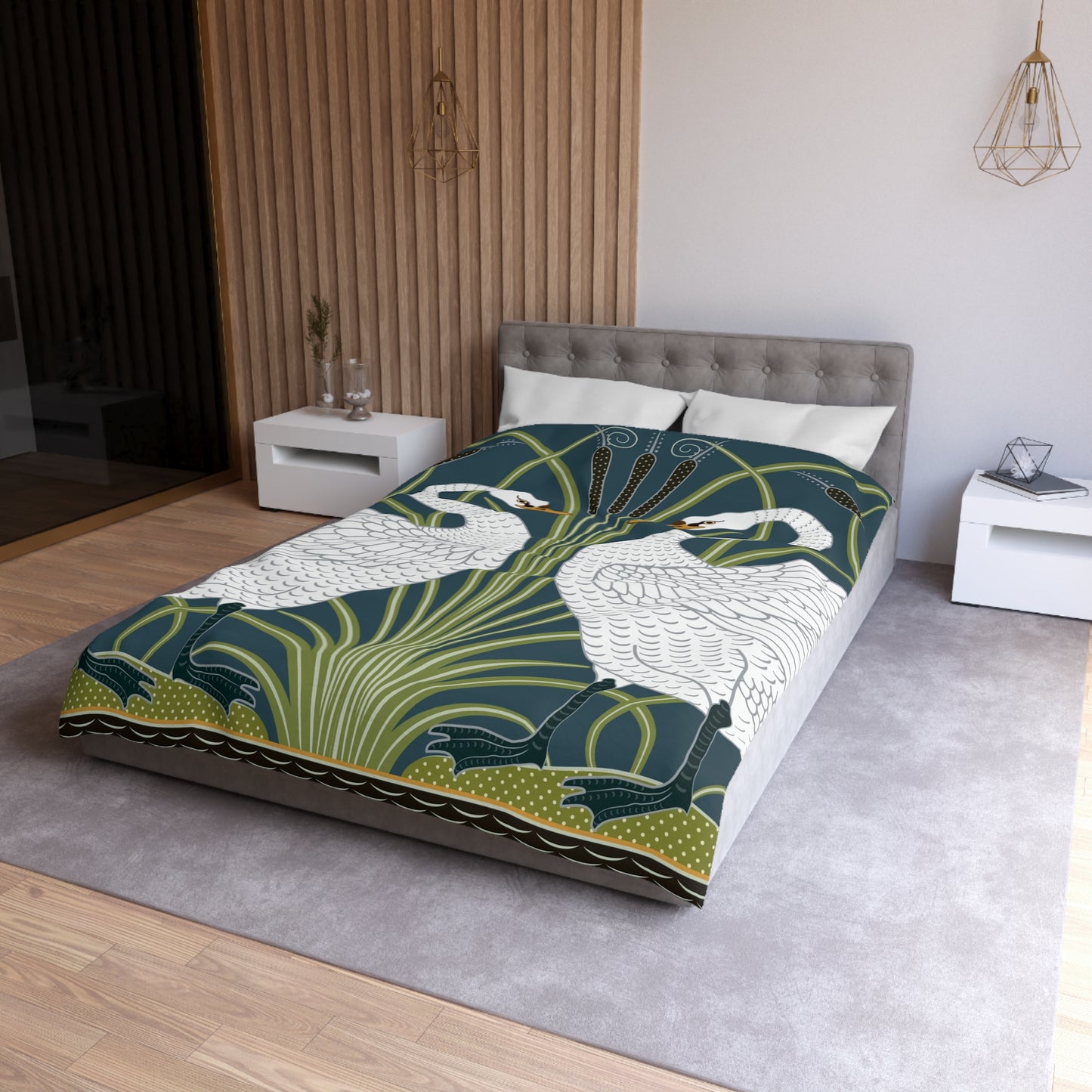 A duvet cover with a William Morris & Co pattern floral and swan pattern, displayed on a bed with pillows.