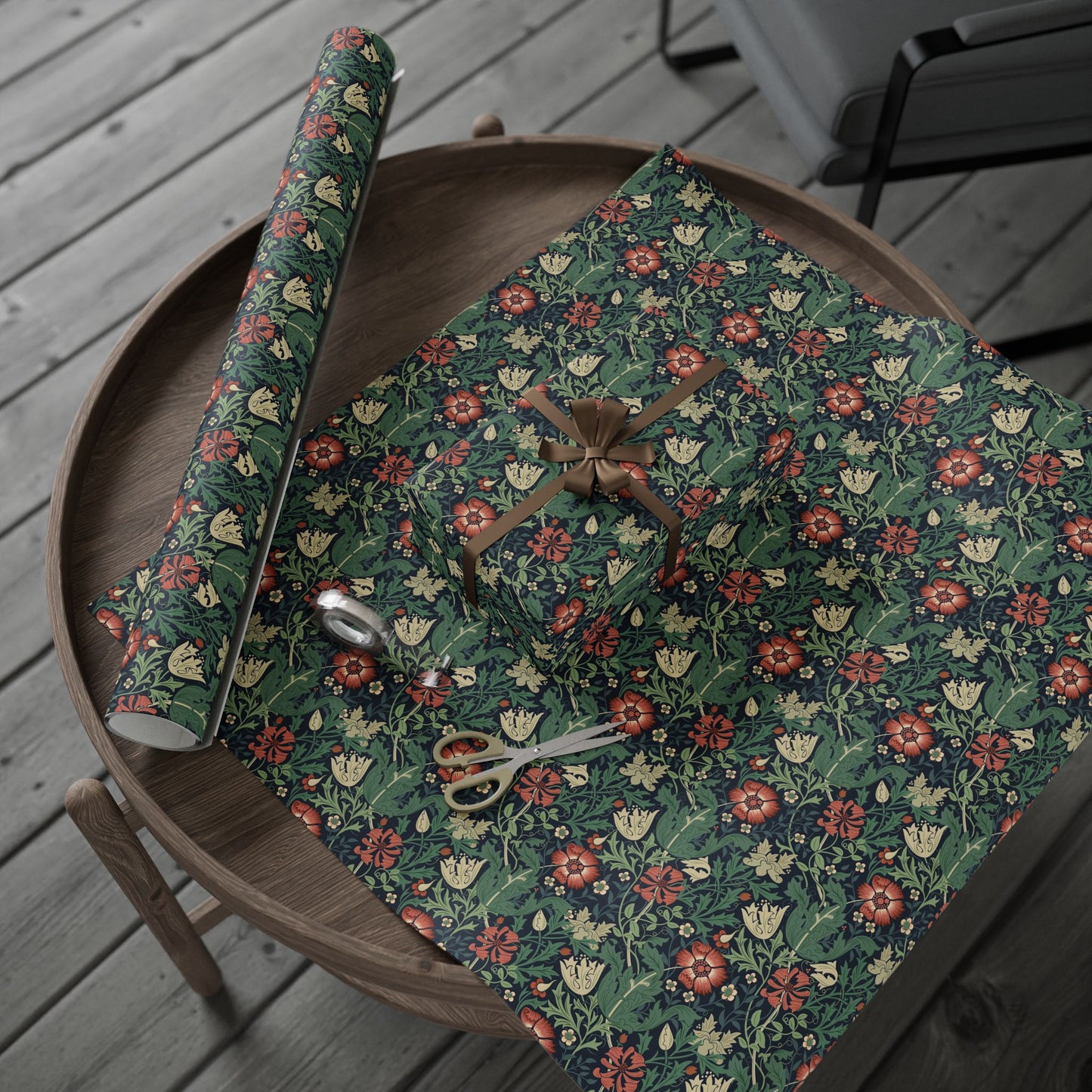 Floral-patterned fabric on a wooden tray with scissors on a wooden deck.