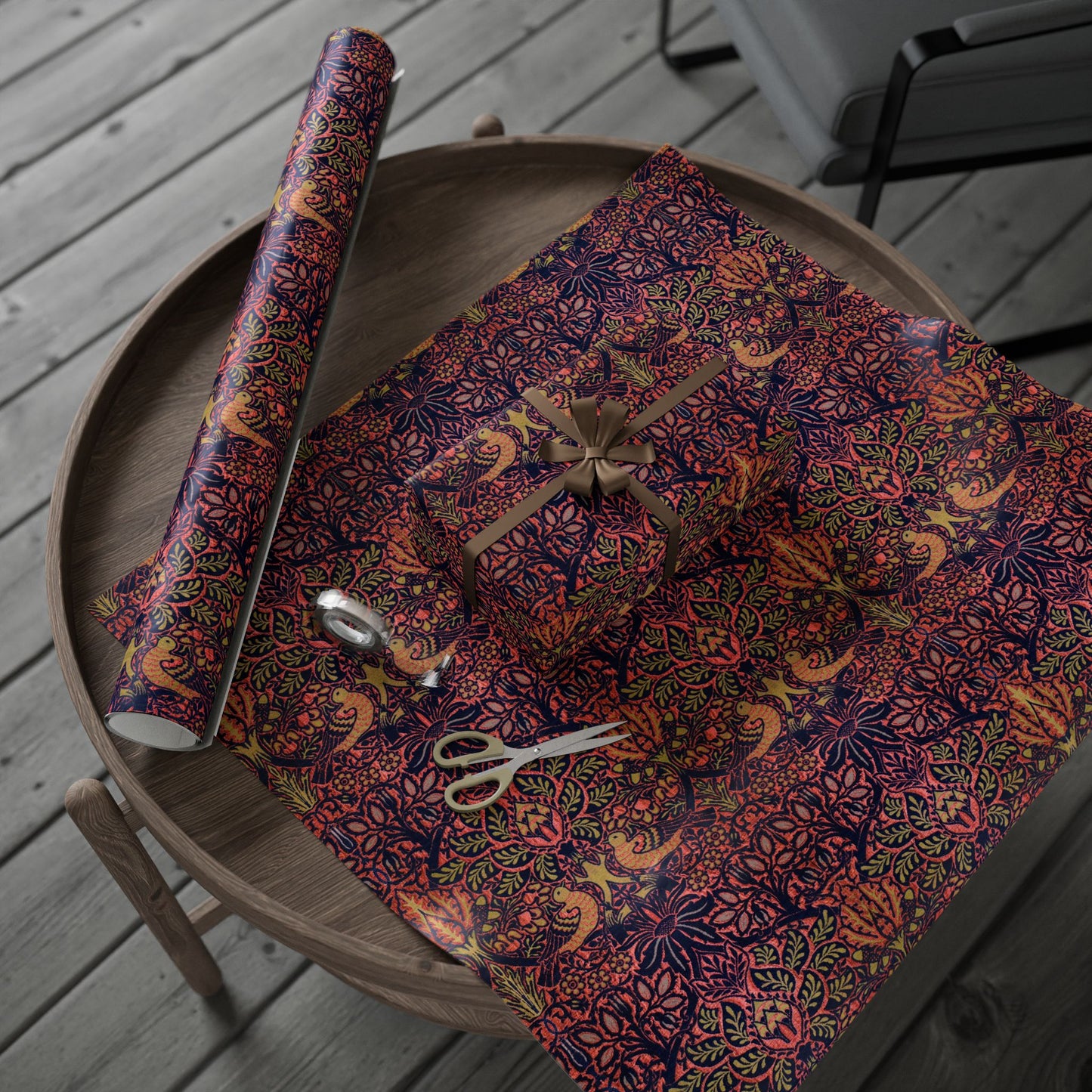 Decorative floral-patterned paper with scissors on a wooden tray outdoors.
