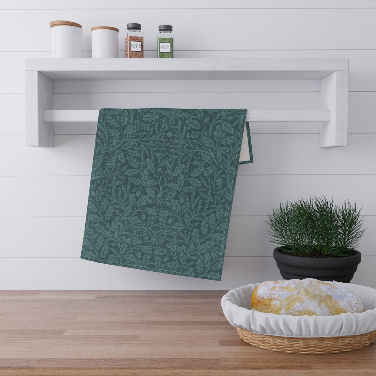 A teal kitchen tea towel with a floral and leaf pattern inspired by William Morris - Acorn and Oak Leaves Collection.