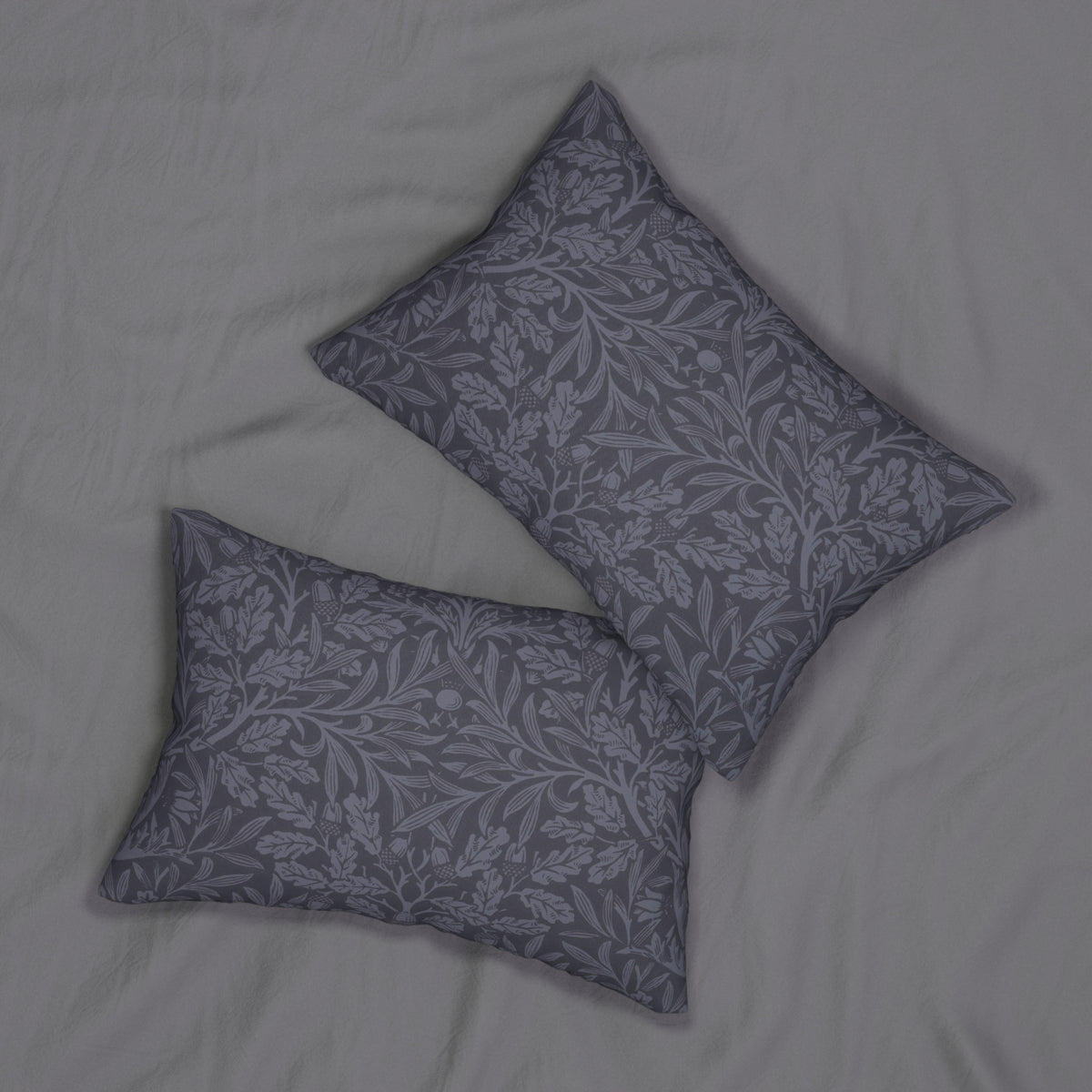 Two square decorative throw pillows with a gray and white floral damask pattern, arranged on a light gray textured fabric background.
