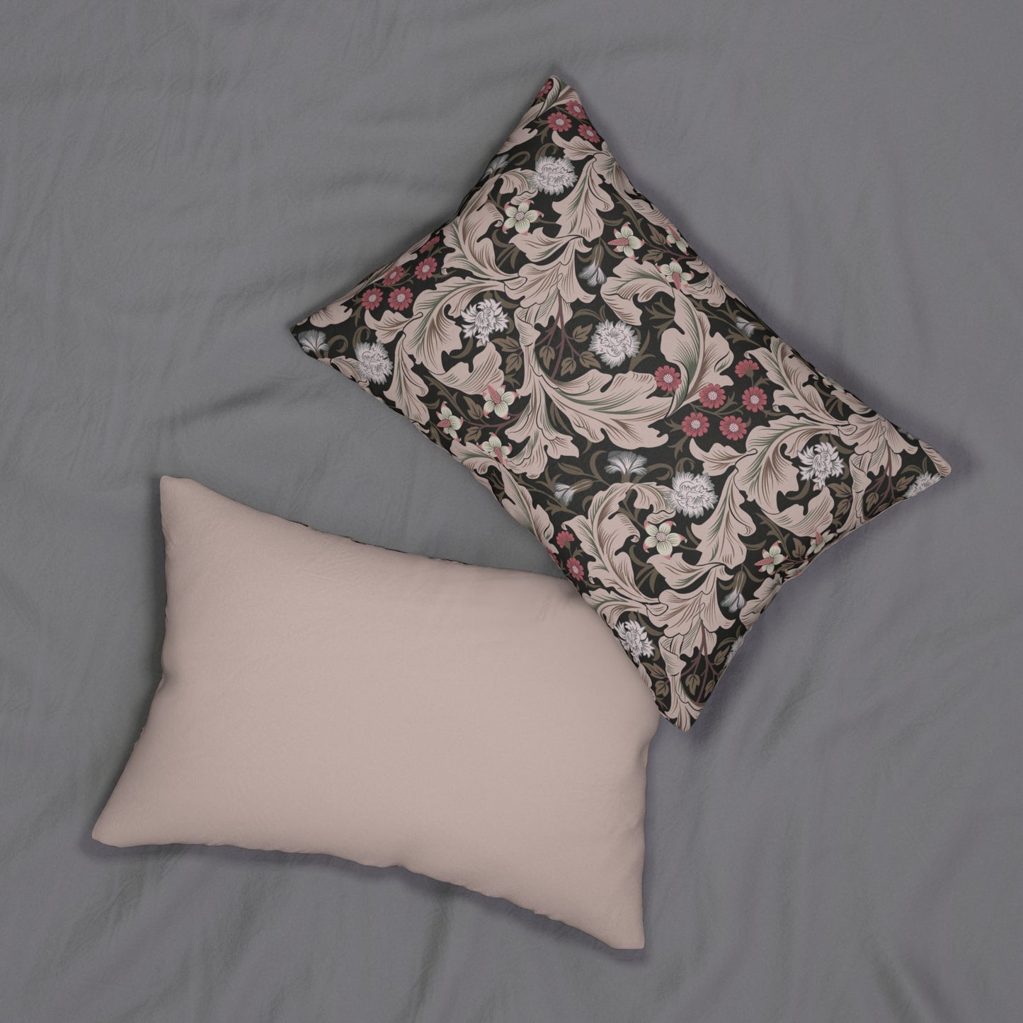 A rectangular lumbar cushion with a floral William Morris & Co pattern in muted colours on a dark background, featuring a concealed zipper.