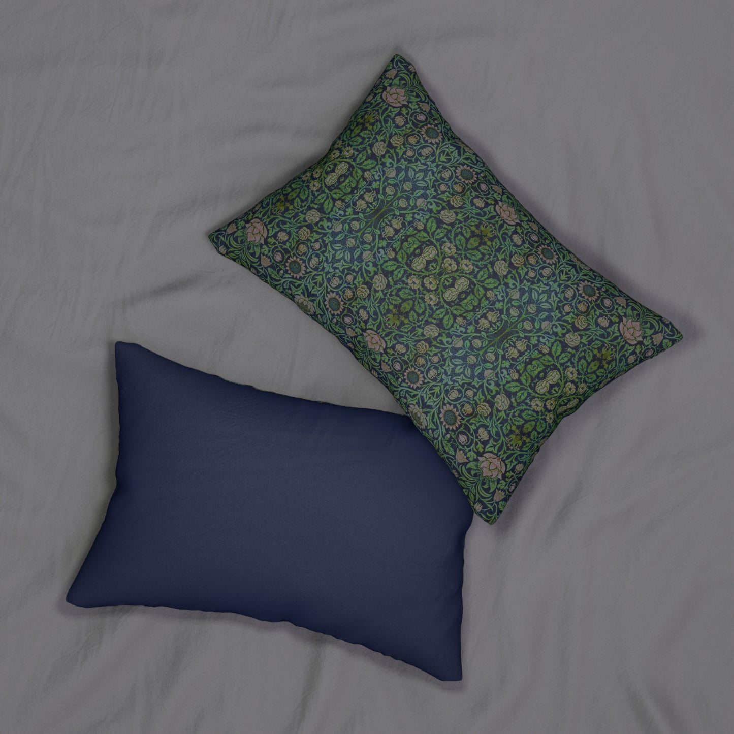 A rectangular lumbar cushion with a green and beige William Morris & Co floral pattern on a dark green background, featuring a concealed beige zipper.