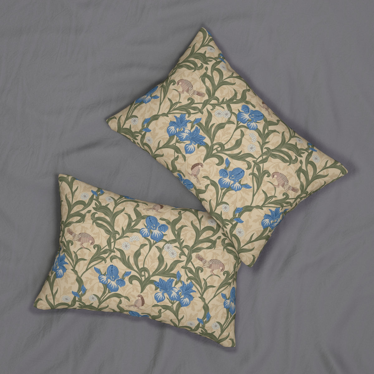 Two rectangular decorative pillows with a floral and botanical pattern in blue, green, and beige, arranged on a gray fabric background.