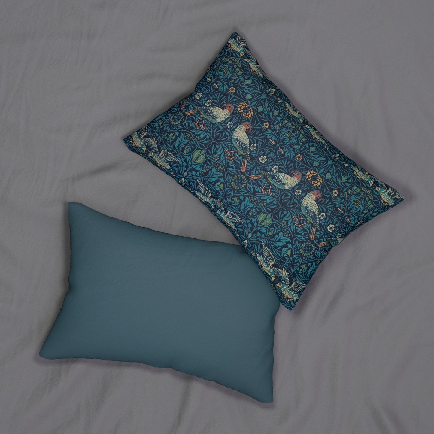A rectangular lumbar cushion with a blue floral and animal pattern inspired by William Morris's art.