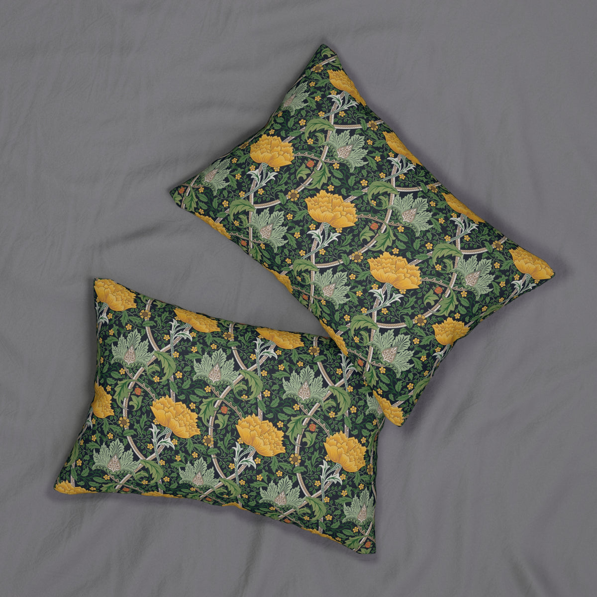 Two decorative throw pillows with a green and yellow floral pattern, arranged on a gray fabric background.