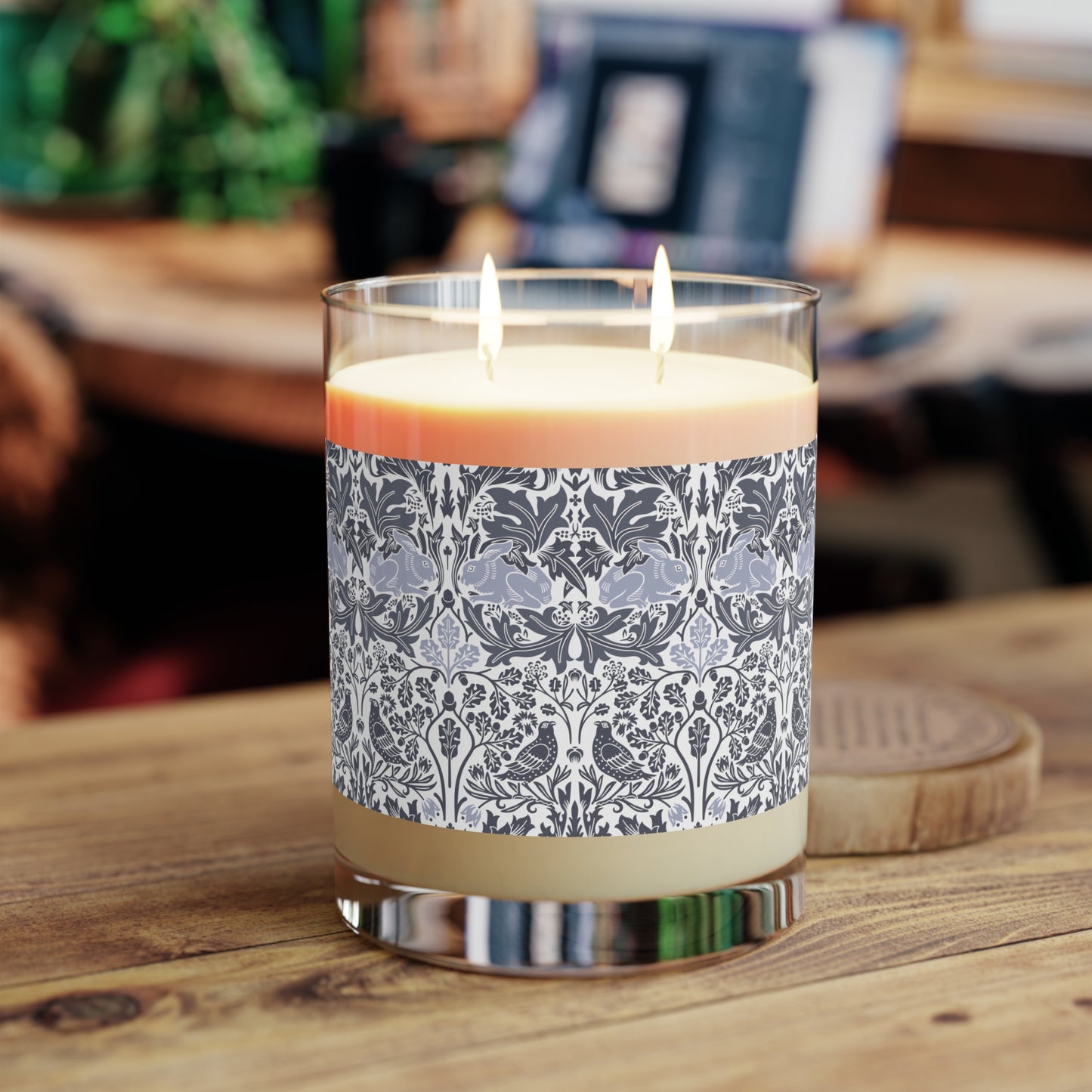 Candle with decorative label on a wooden surface