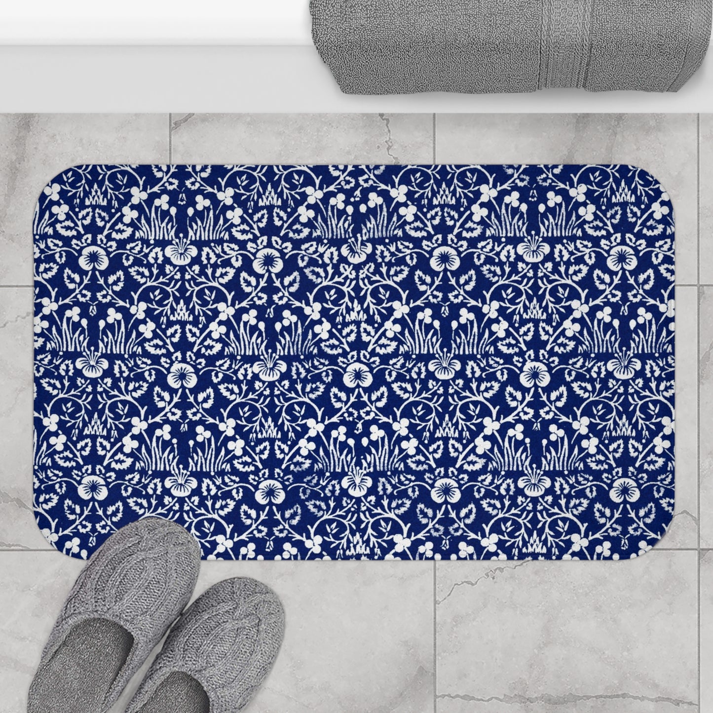 A rectangular microfibre bath mat with a blue floral pattern inspired by William Morris.