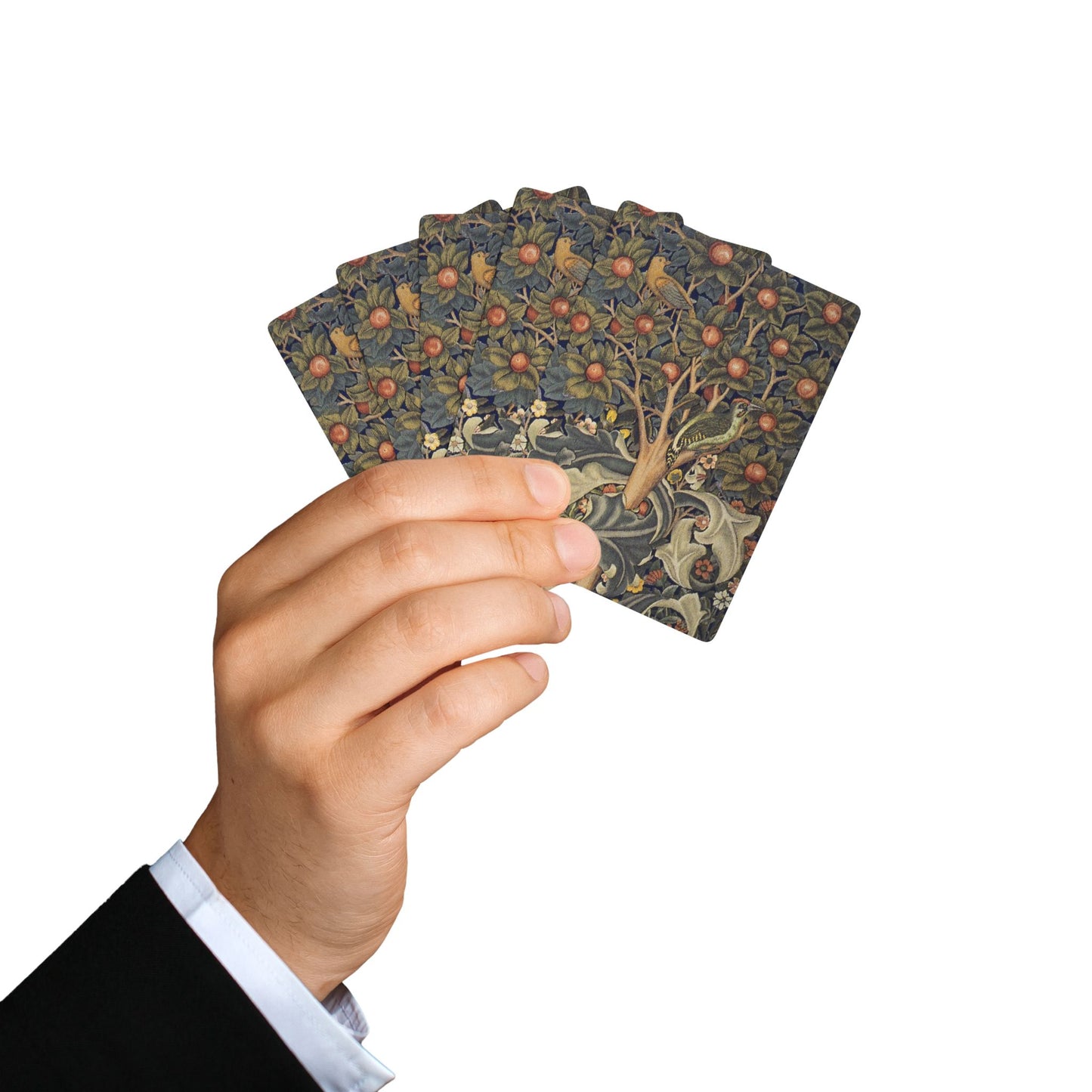 Hand holding a deck of playing cards with intricate designs on a white background