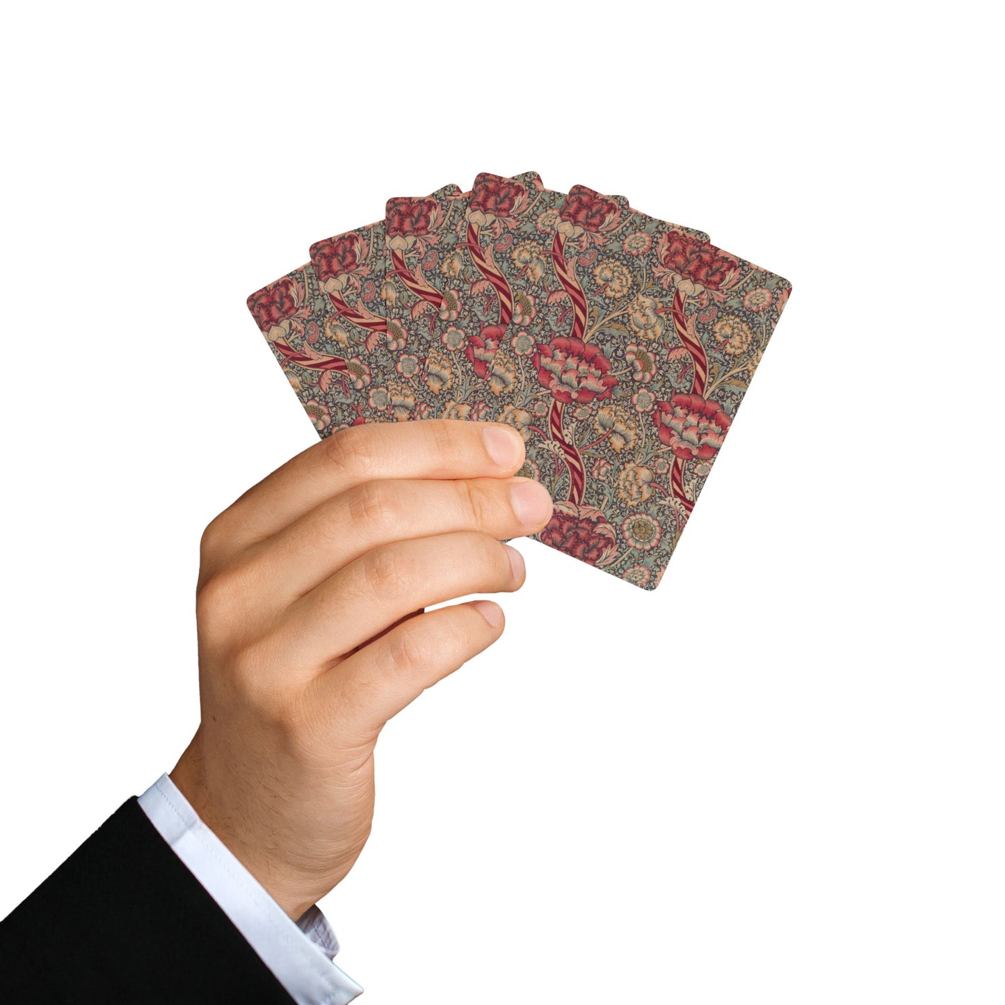 Hand holding a deck of patterned playing cards against a white background