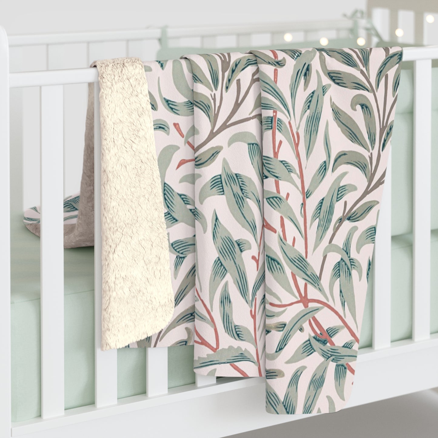 Floral-patterned blanket draped over a white crib