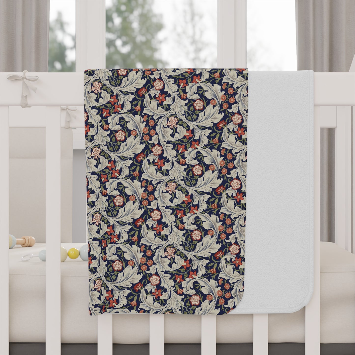 A toddler blanket with a floral pattern inspired by William Morris, in vibrant colours on a white background.