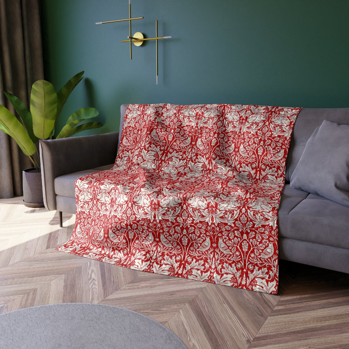 Red and white patterned blanket draped over a gray sofa in a living room.