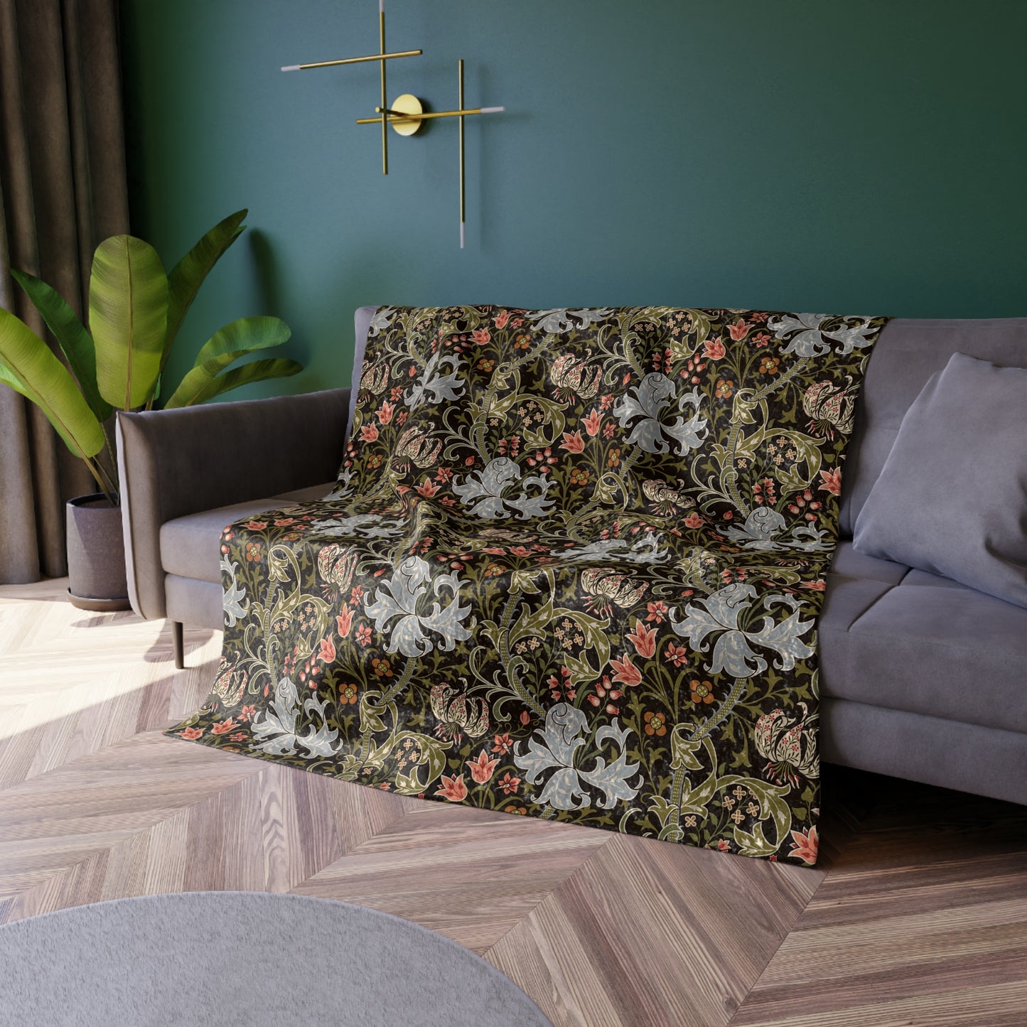 A lush crushed velvet blanket with a floral pattern inspired by William Morris, in shades of green and brown, with hemmed edges and a silky finish.