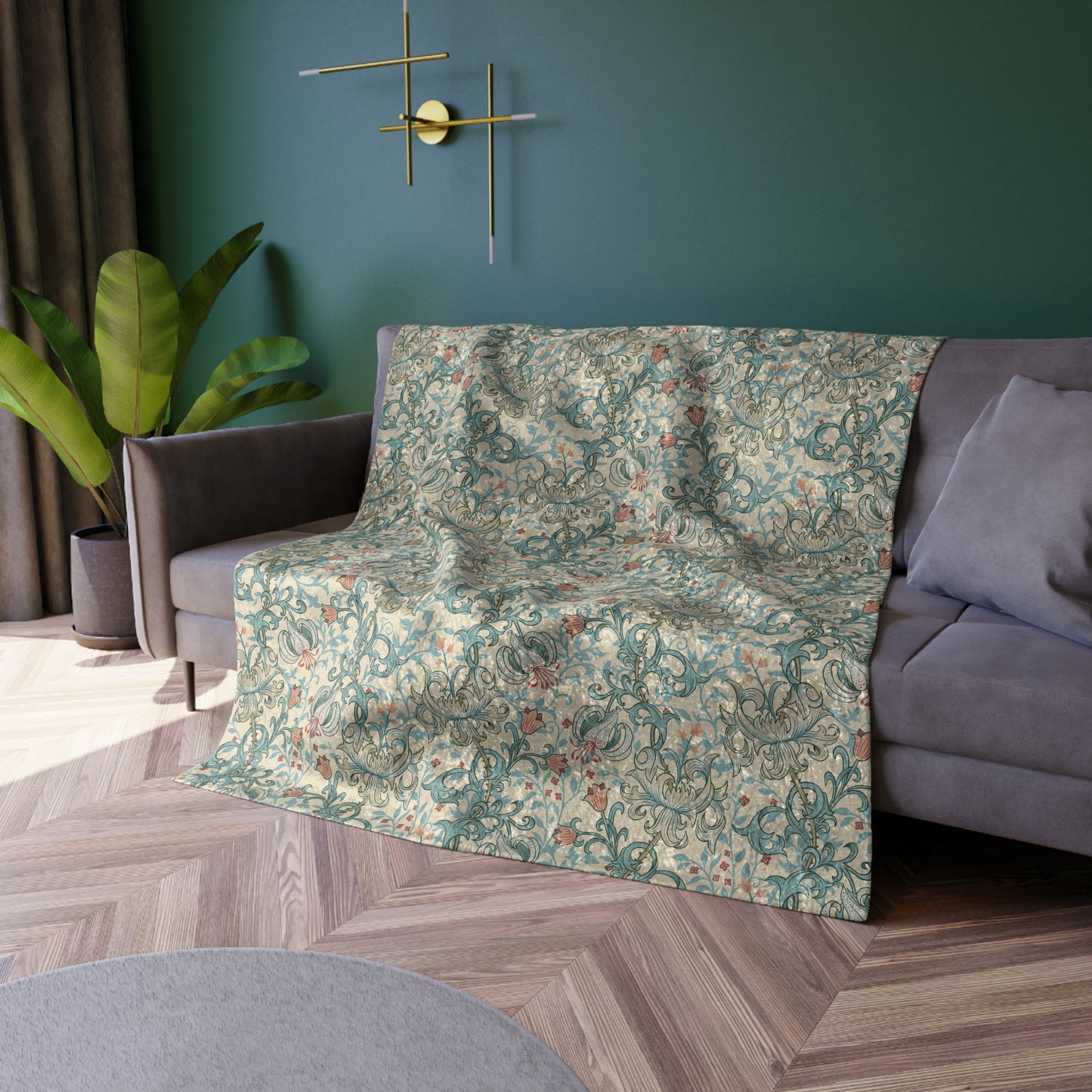 A plush velvet blanket with a floral pattern in a mineral colour palette, folded neatly to show both the patterned side and the silky reverse.