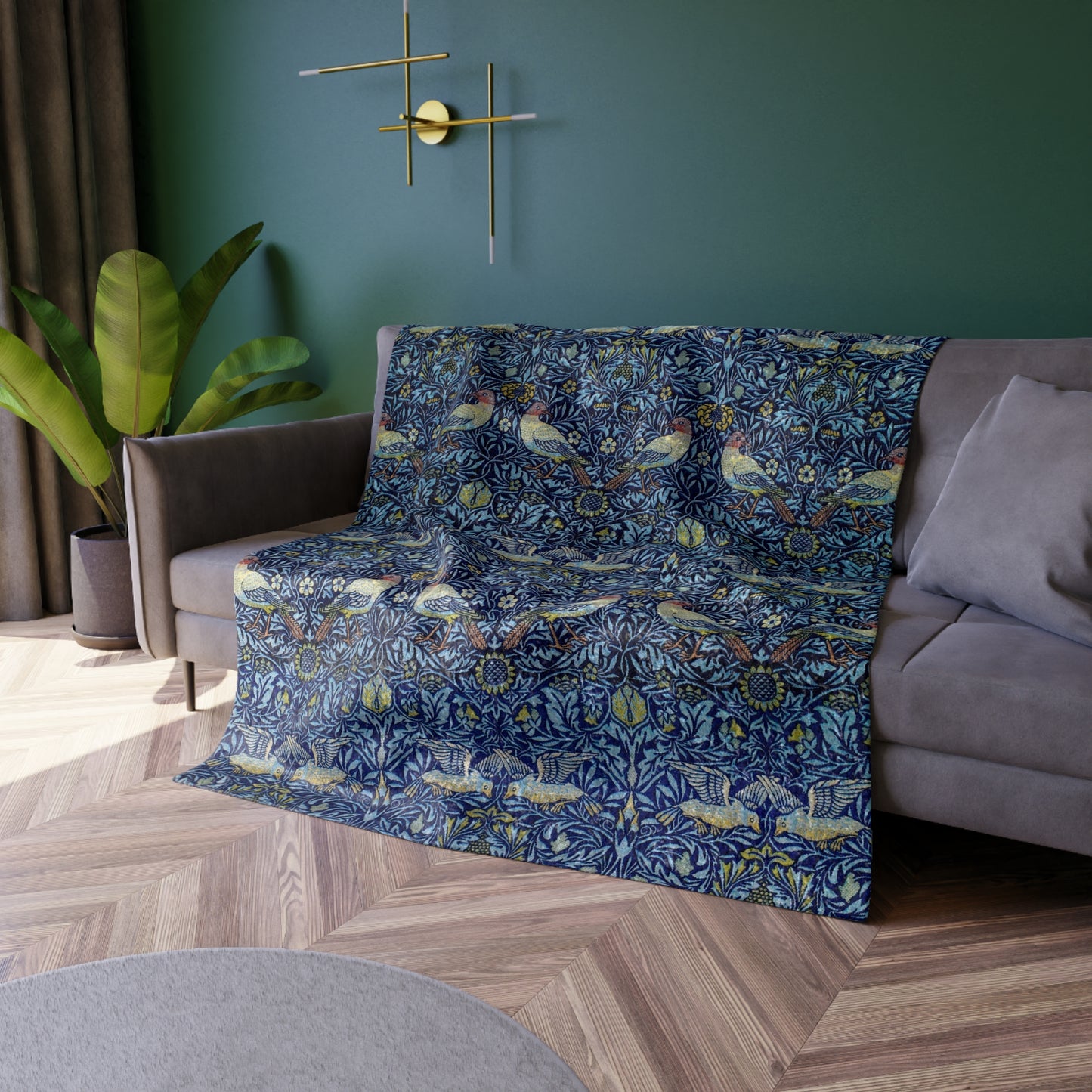 A lush crushed velvet blanket with a blue floral William Morris & Co pattern on the surface and a silky finish, hemmed edges, and a white interior visible at one end.