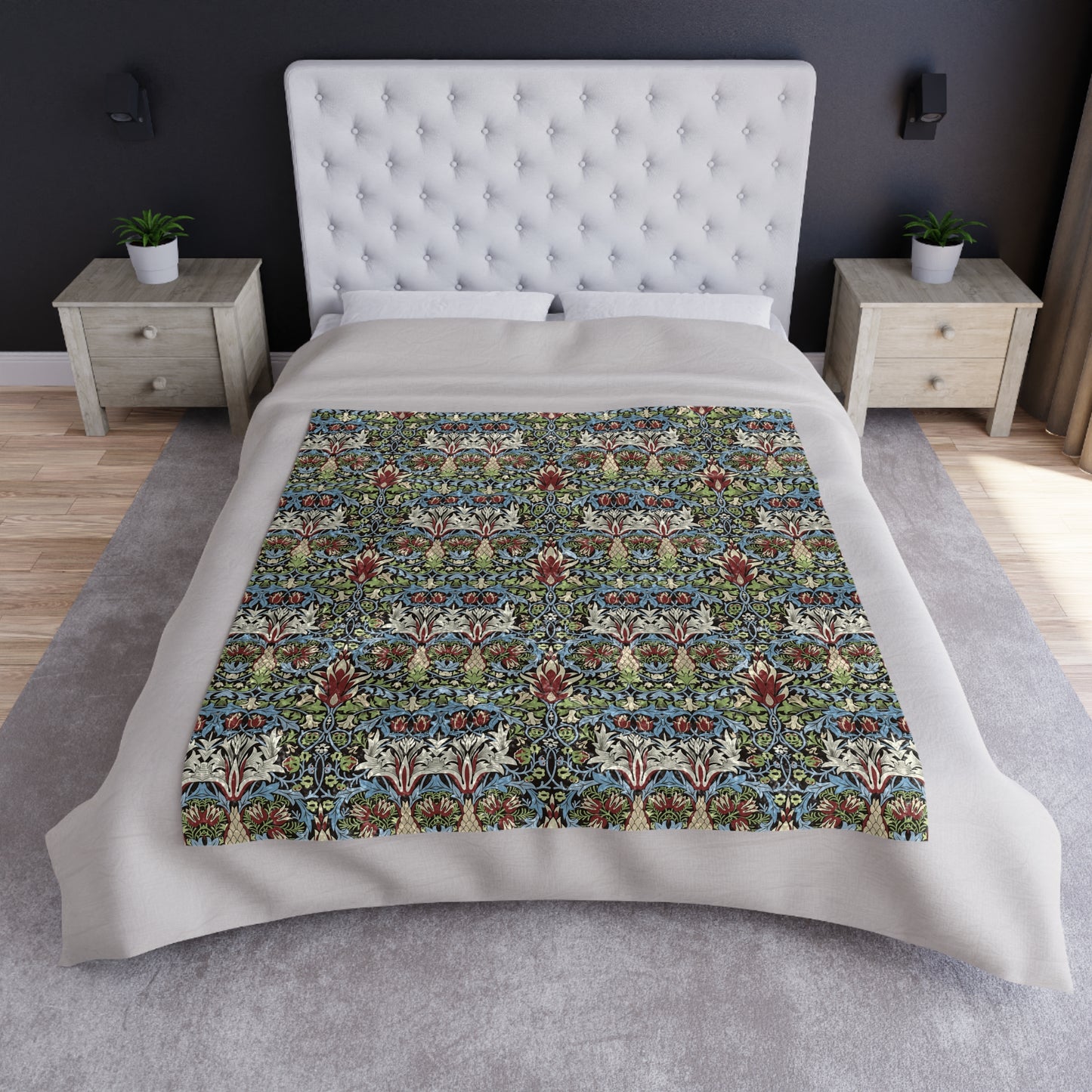 Bed with floral patterned comforter in a bedroom setting