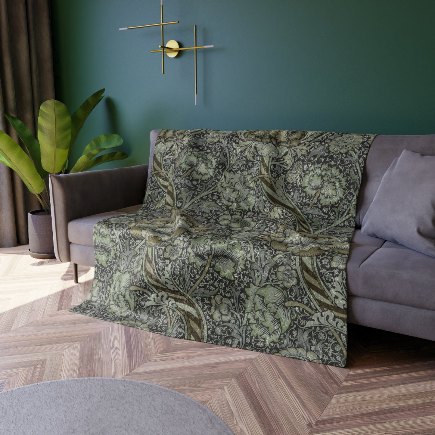 A crushed velvet blanket with a floral pattern in muted colors, folded to show both the patterned side and the solid gray reverse.