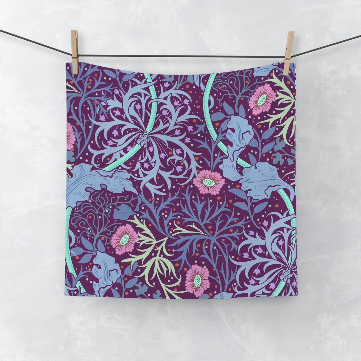 A multicolored floral patterned washcloth inspired by William Morris' Seaweed Collection with a pink flower motif.