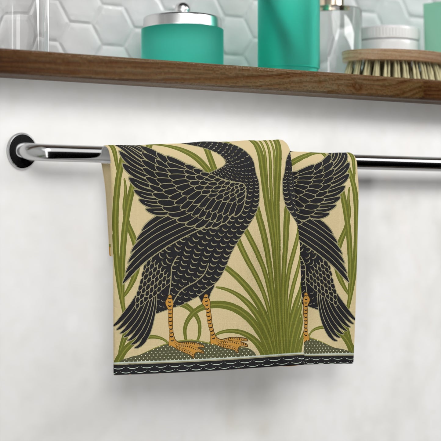 Towel with bird design hanging on a rack in a bathroom setting