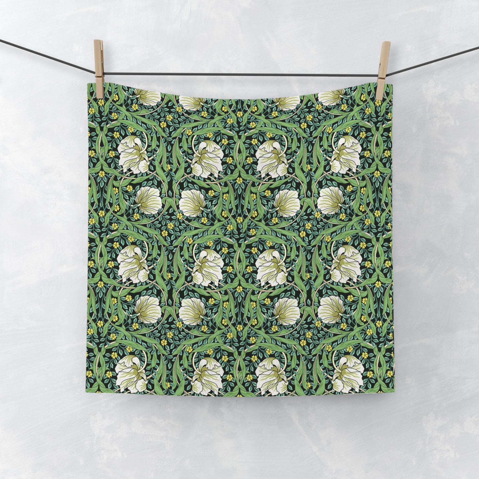 Floral patterned fabric hanging on a line against a white background
