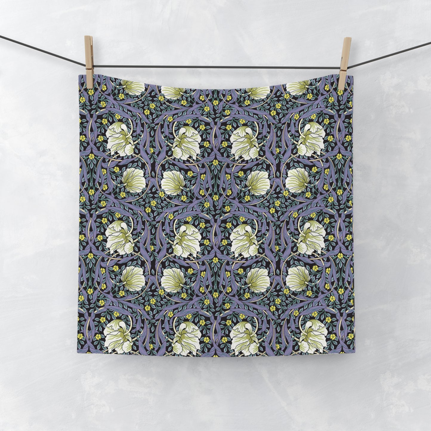 Floral patterned fabric hanging on a line against a white background