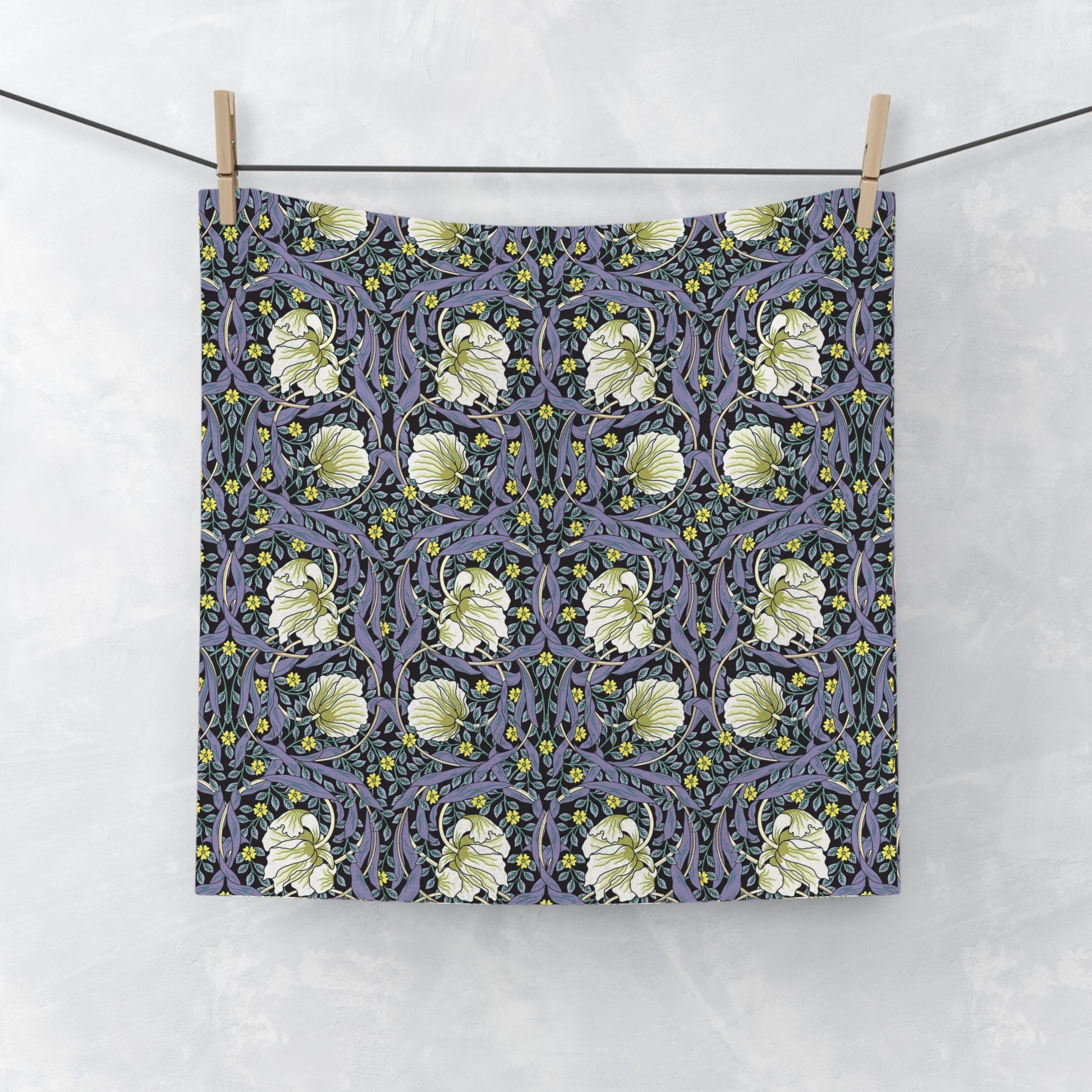 Floral patterned fabric hanging on a line against a white background