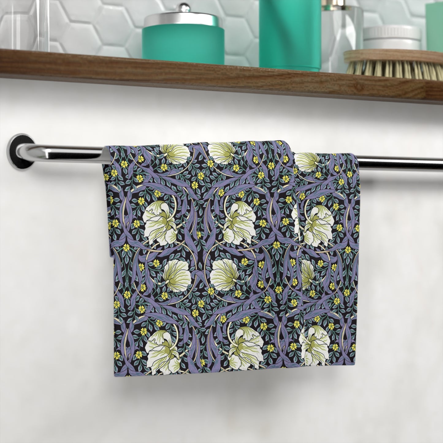 Floral patterned towel hanging on a rack in a bathroom setting