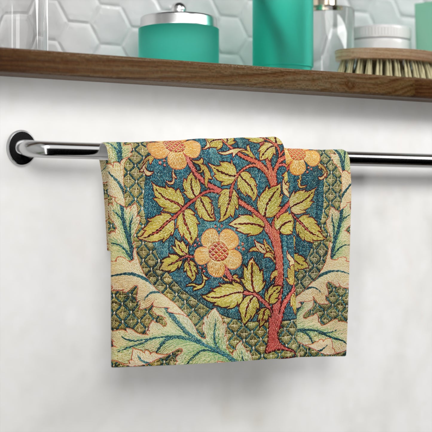 Decorative towel with floral pattern hanging on a towel rack in a bathroom.