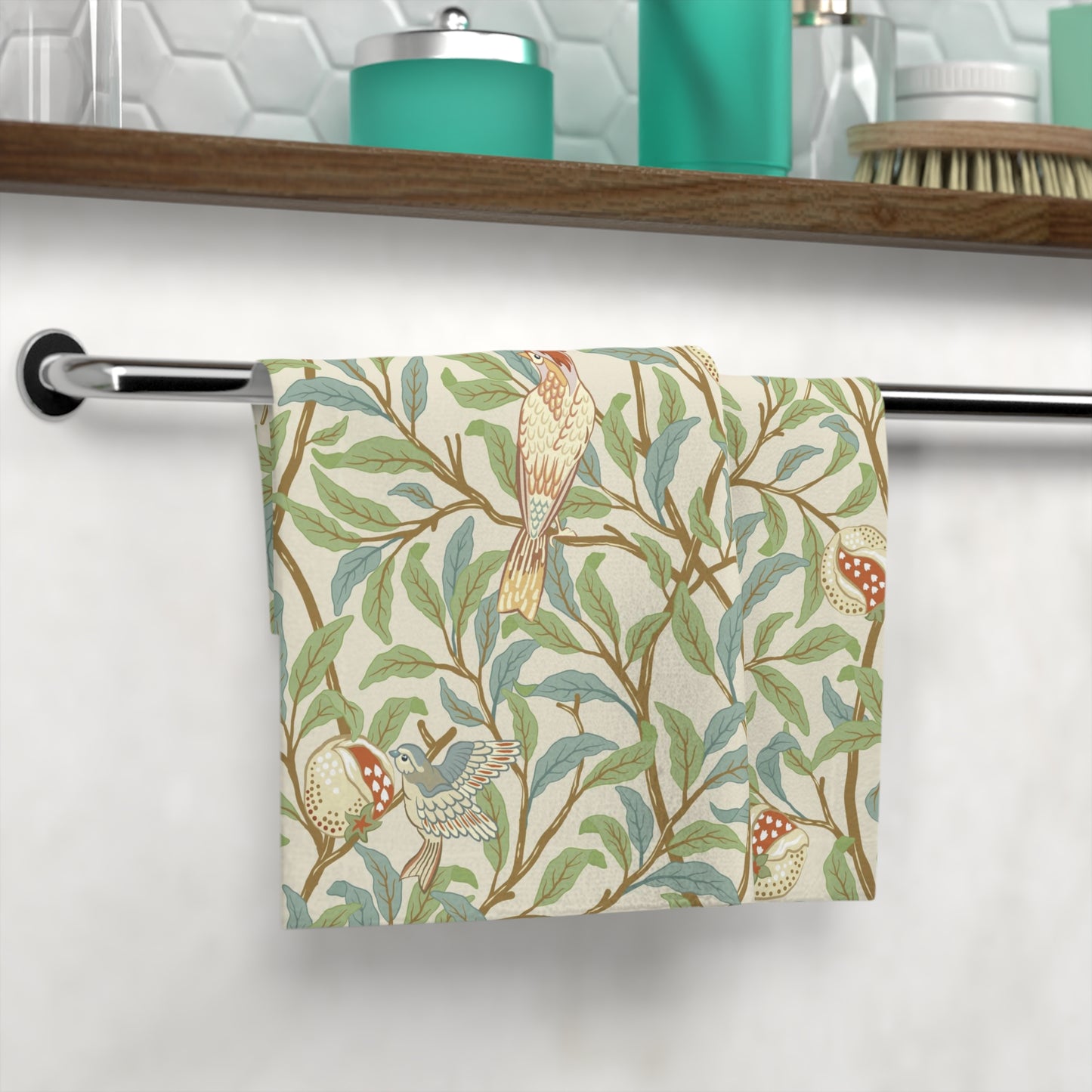 A white washcloth with a floral pattern inspired by William Morris, featuring birds and pomegranate designs on a parchment background.