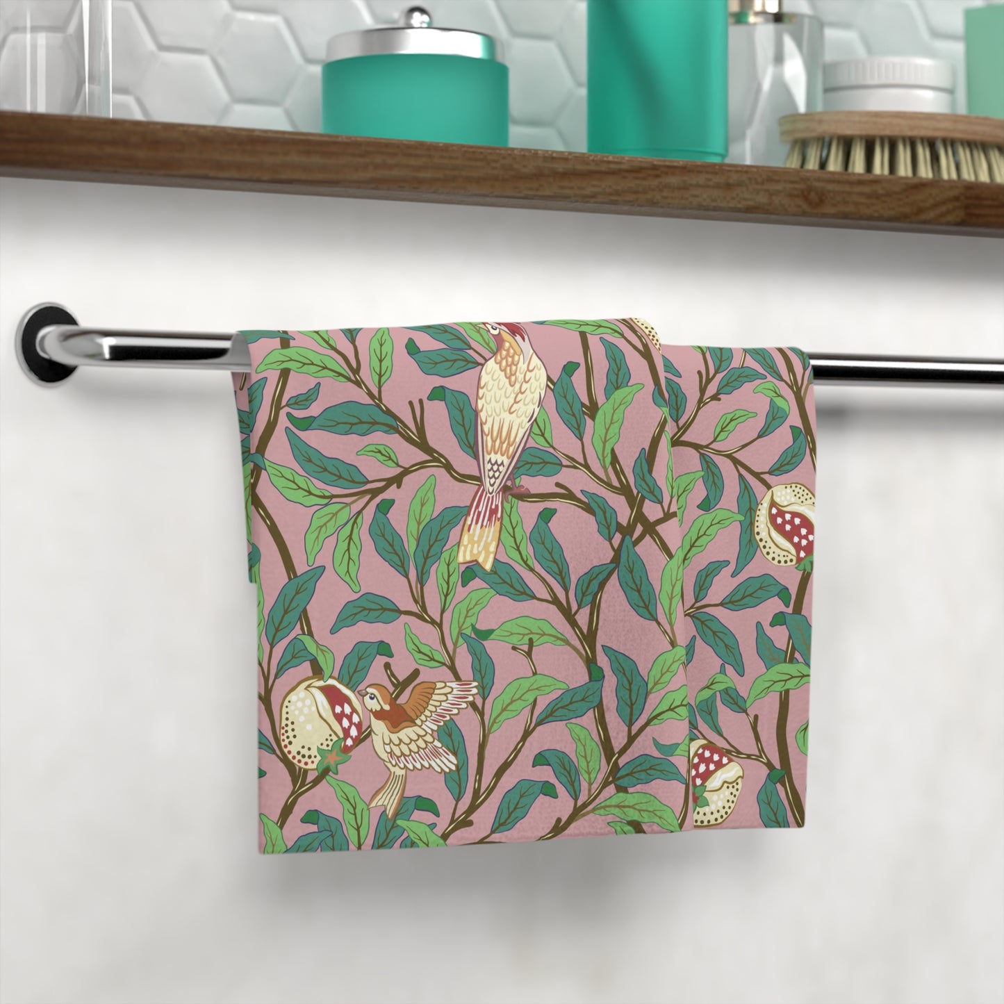 A white washcloth with a floral pattern featuring birds and pomegranates, inspired by William Morris' Bird & Pomegranate Collection.