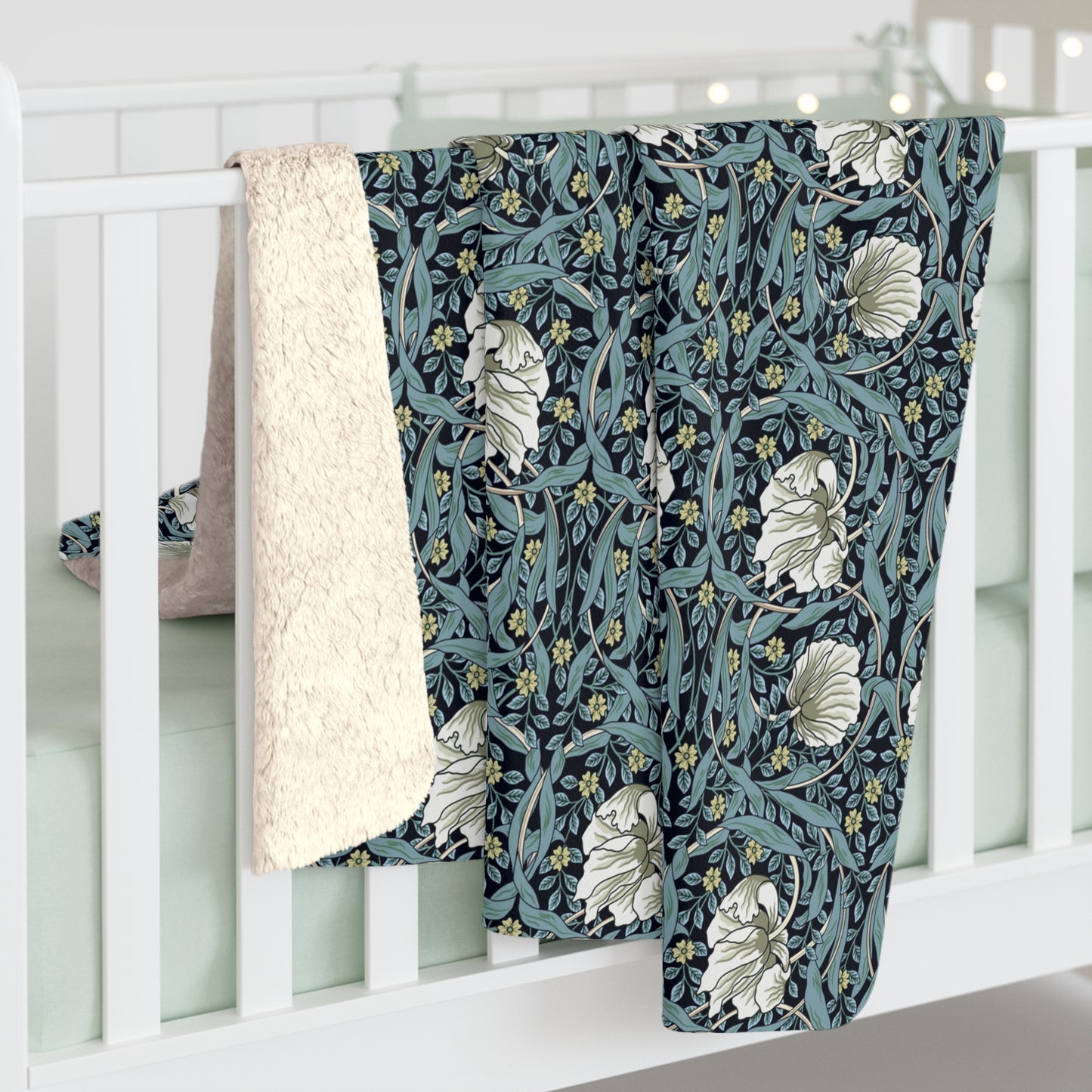 A plush fleece blanket with a geometric William Morris & Co pattern in a slate blue colour, featuring a dense, cozy texture.